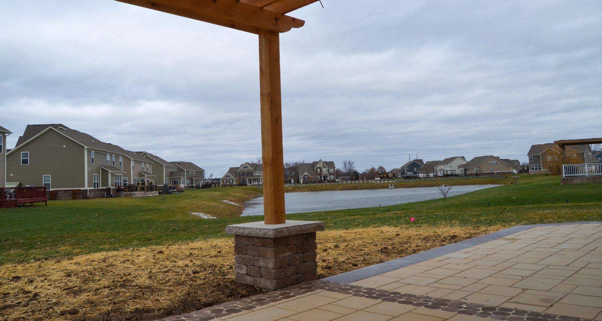 Greenwood House Side View Precision Outdoors Greenwood Indiana exterior design cedar pergola paver patio unlock belgard paver cedar pergola block view materials
