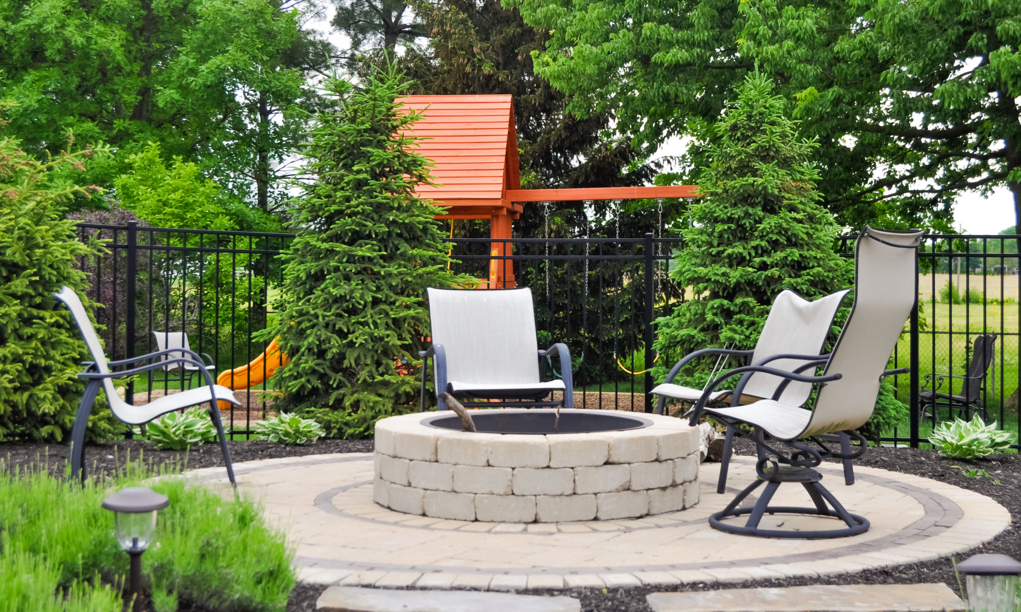 Precision Outdoors Franklin Township Retaining Wall Fire Pit and Patio Travertine paver patio natural cooling slip resistant texture rebuild restoration blocks fire pit space stone walkway perimeter landscaping custom personal privacy pool are a playground pad build mulch installation entertaining Avon indiana