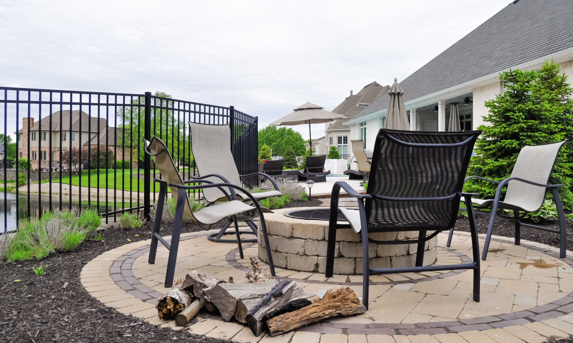 Precision Outdoors Franklin Township Retaining Wall Fire Pit and Patio Travertine paver patio natural cooling slip resistant texture rebuild restoration blocks fire pit space stone walkway perimeter landscaping custom personal privacy pool are a playground pad build mulch installation entertaining Avon indiana