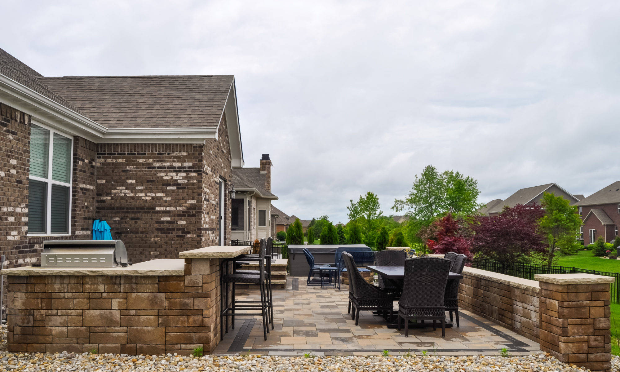 Precision Outdoors Center Grove grill paver patio & retaining wall builtin built-in outdoor kitchen extended bar seating hang out gathering paver patio belgard moduline paver material retaining wall kitchen veneer Ashlar tandem backyard landscaping rock bed trees bulbs shrubs entertaining space