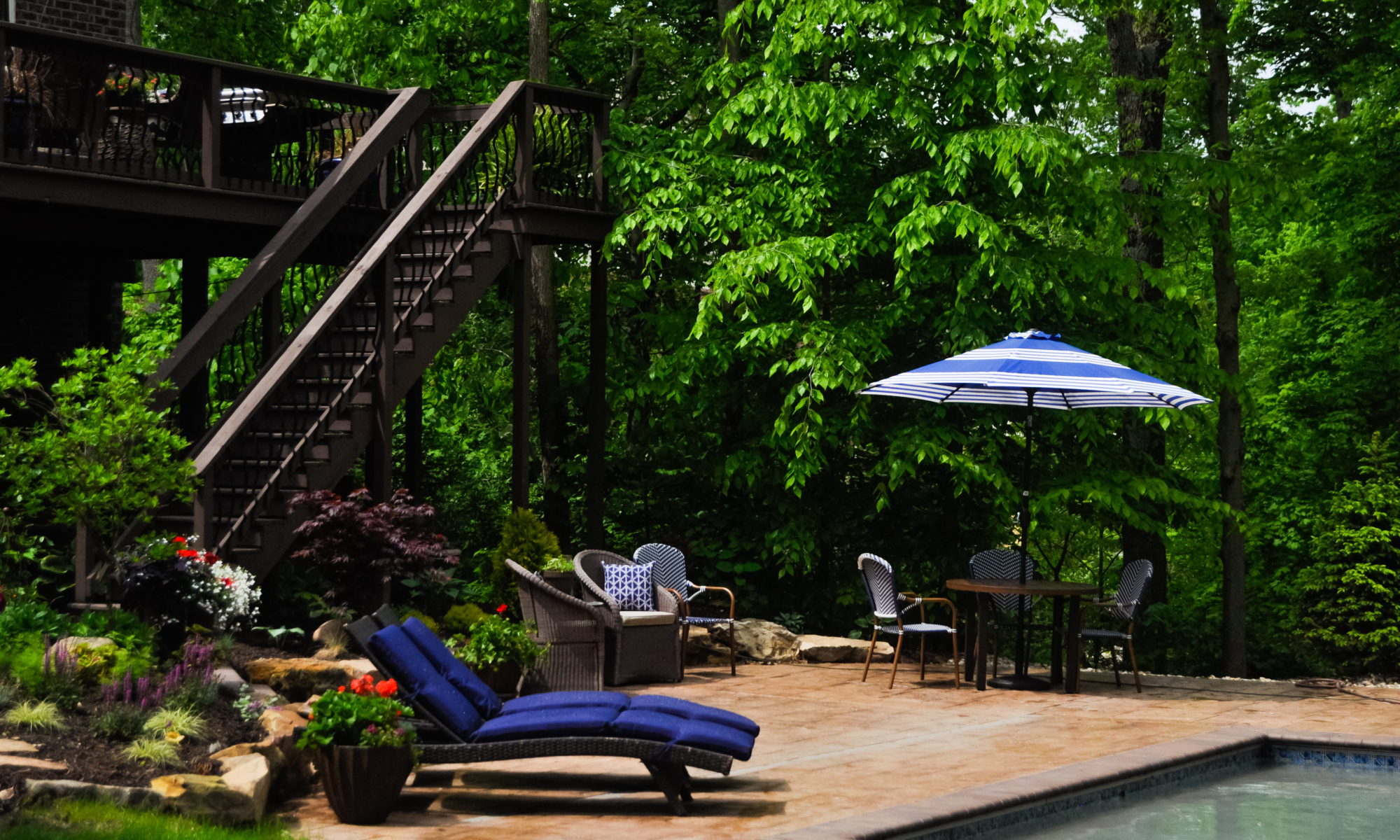 Precision Outdoors Avon patio & structure specialty built a-frame textured fireplace chimney pergola inspired structure decor additional seating raised sundeck tanning relaxation stamped concrete patio wrap around seating wall aesthetic style stone steps outdoor elements Avon indiana dream backyard pool