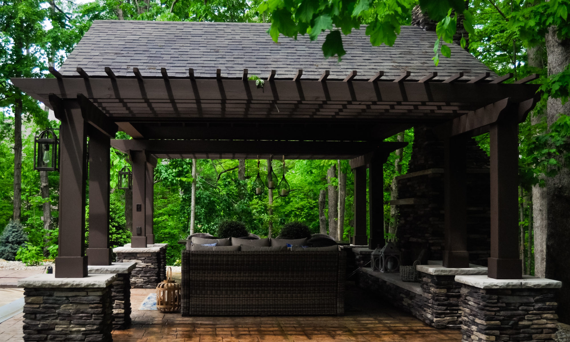 Precision Outdoors Avon patio & structure specialty built a-frame textured fireplace chimney pergola inspired structure decor additional seating raised sundeck tanning relaxation stamped concrete patio wrap around seating wall aesthetic style stone steps outdoor elements Avon indiana dream backyard pool