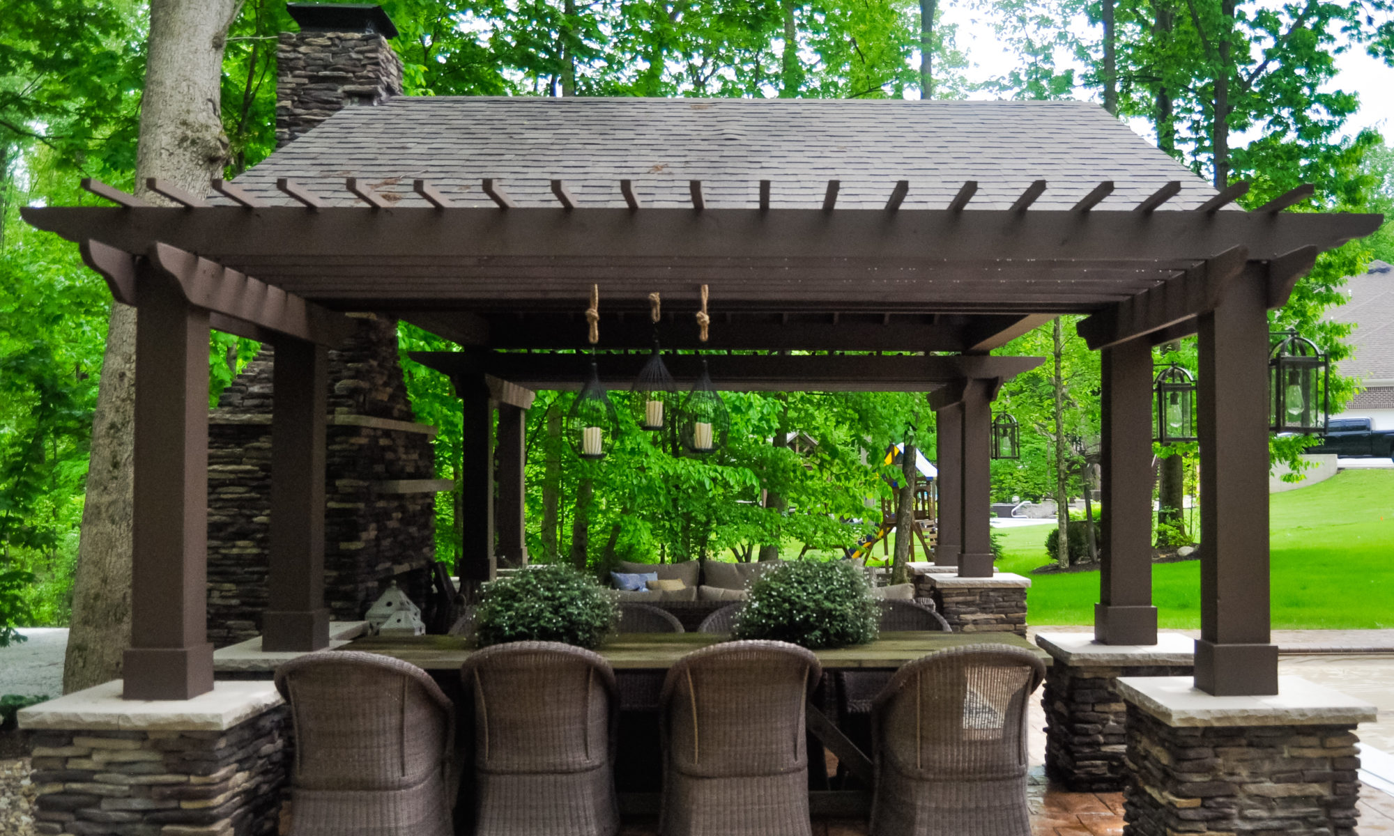 Precision Outdoors Avon patio & structure specialty built a-frame textured fireplace chimney pergola inspired structure decor additional seating raised sundeck tanning relaxation stamped concrete patio wrap around seating wall aesthetic style stone steps outdoor elements Avon indiana dream backyard pool