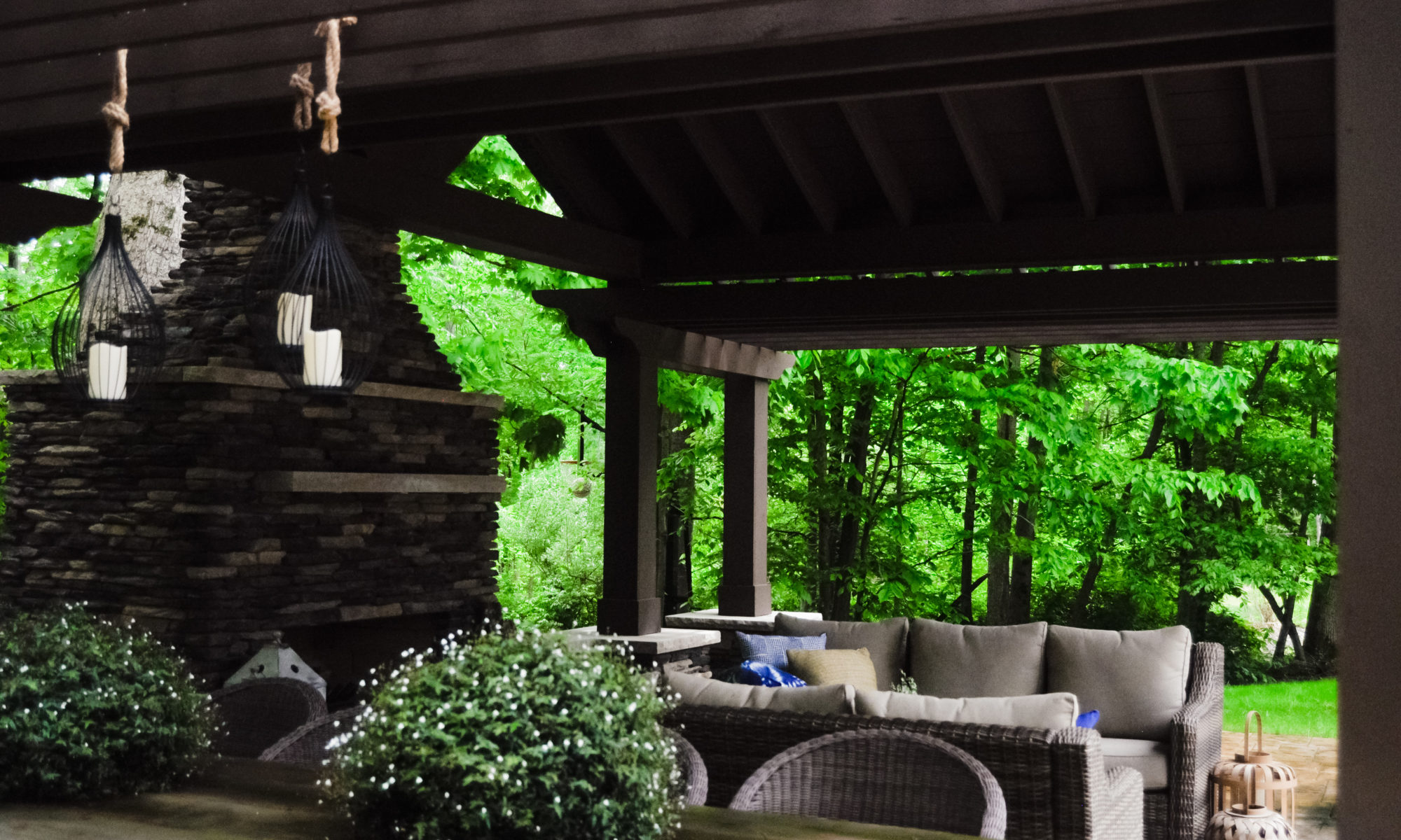 Precision Outdoors Avon patio & structure specialty built a-frame textured fireplace chimney pergola inspired structure decor additional seating raised sundeck tanning relaxation stamped concrete patio wrap around seating wall aesthetic style stone steps outdoor elements Avon indiana dream backyard pool
