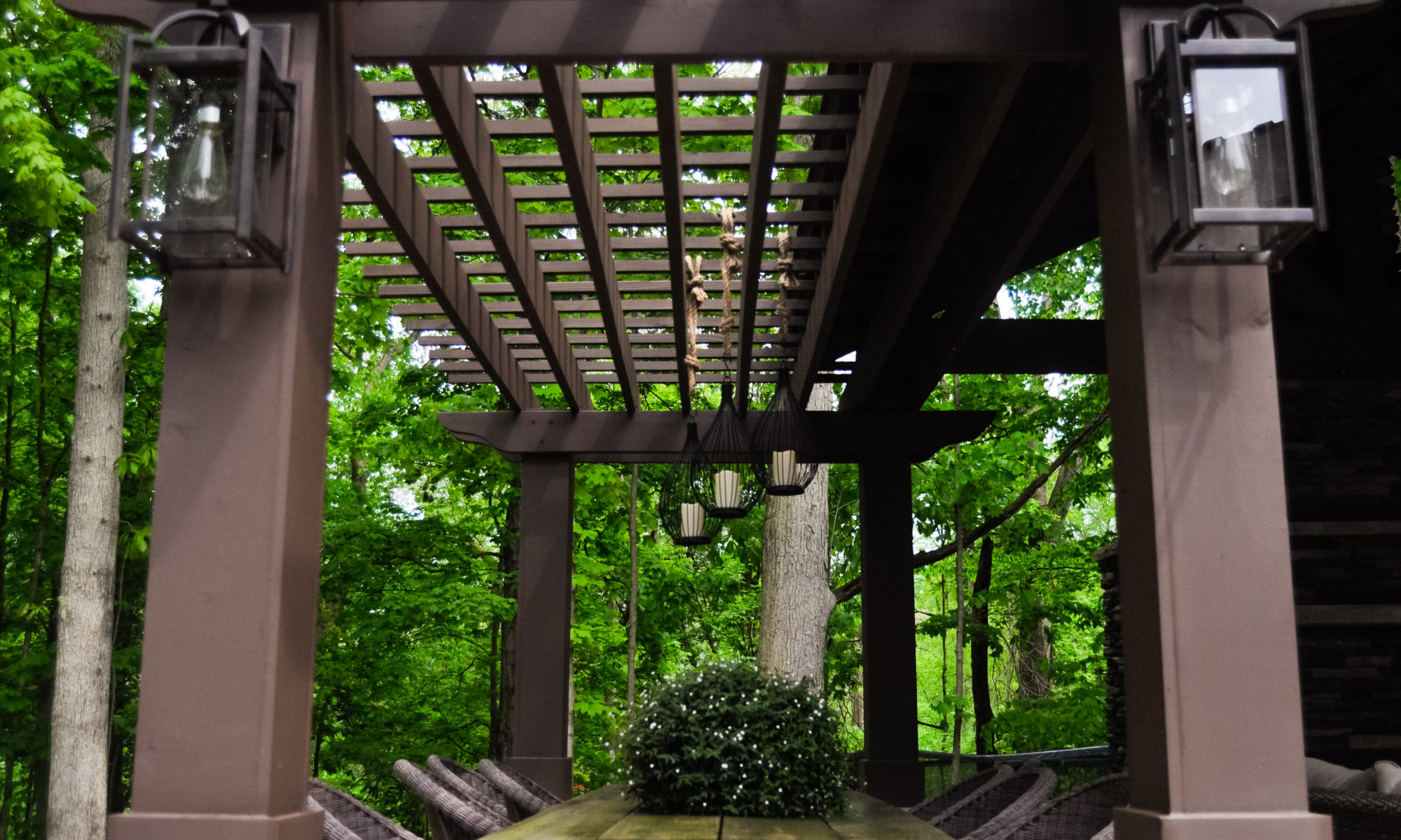 Precision Outdoors Avon patio & structure specialty built a-frame textured fireplace chimney pergola inspired structure decor additional seating raised sundeck tanning relaxation stamped concrete patio wrap around seating wall aesthetic style stone steps outdoor elements Avon indiana dream backyard pool