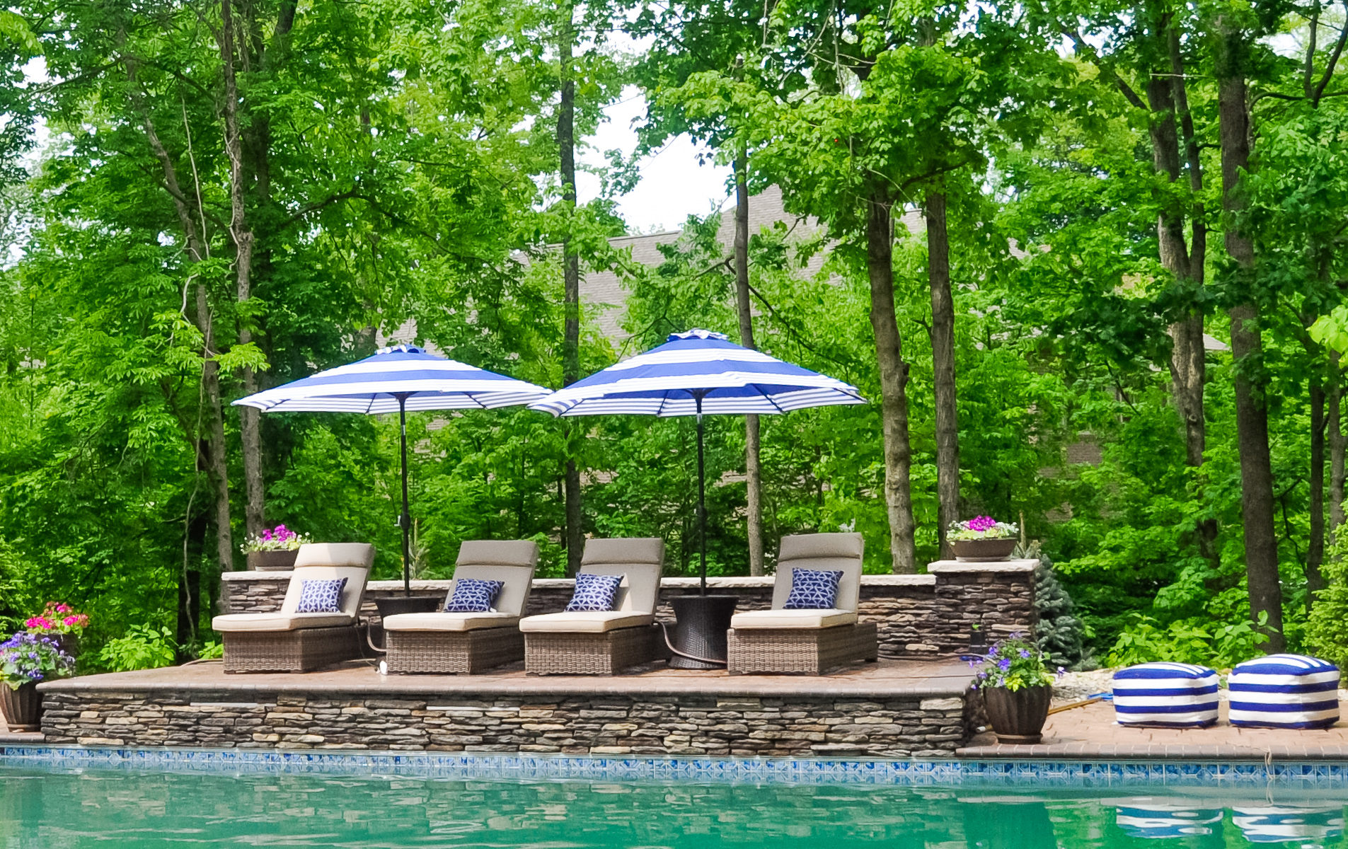 Precision Outdoors Avon patio & structure specialty built a-frame textured fireplace chimney pergola inspired structure decor additional seating raised sundeck tanning relaxation stamped concrete patio wrap around seating wall aesthetic style stone steps outdoor elements Avon indiana dream backyard pool