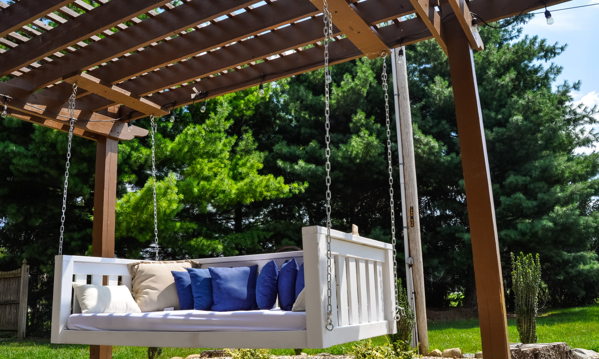 Precision Outdoors Pergola & Patio Cedar Pergola wrap around gathering entertaining custom built furniture bench swing three piece deck chair set playground pad play space simple concrete patio installation custom daybed swing Greenwood indiana