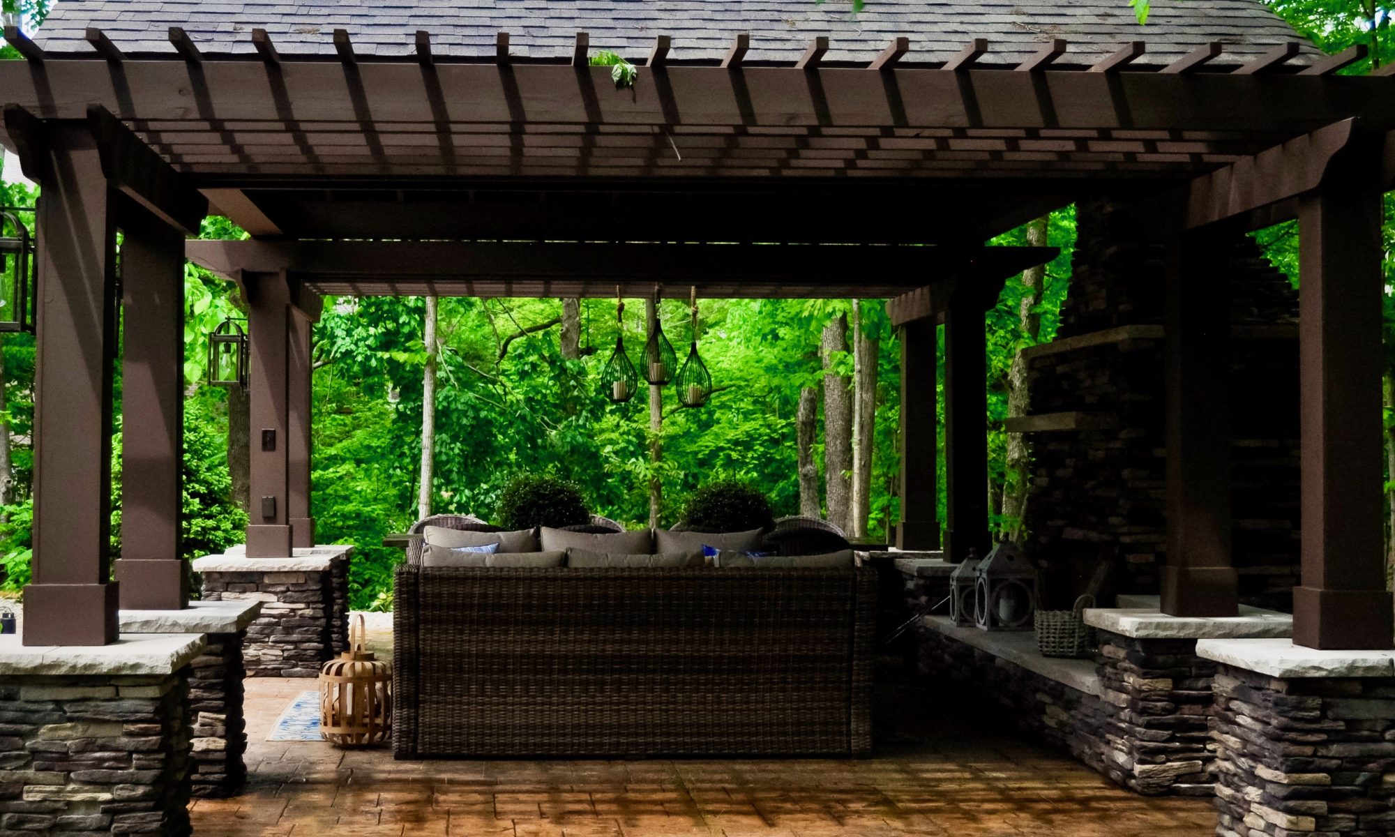 Precision Outdoors Avon patio & structure specialty built a-frame textured fireplace chimney pergola inspired structure decor additional seating raised sundeck tanning relaxation stamped concrete patio wrap around seating wall aesthetic style stone steps outdoor elements Avon indiana dream backyard pool