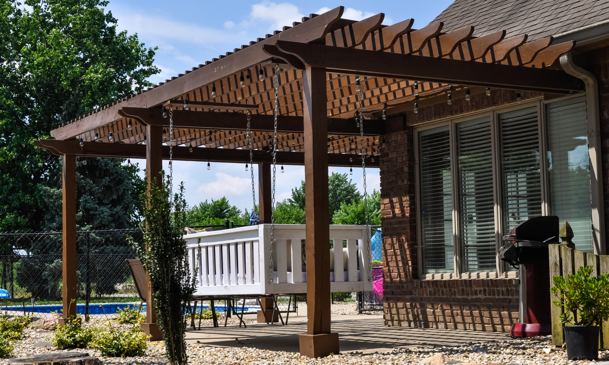 Precision Outdoors Pergola & Patio Cedar Pergola wrap around gathering entertaining custom built furniture bench swing three piece deck chair set playground pad play space simple concrete patio installation custom daybed swing Greenwood indiana