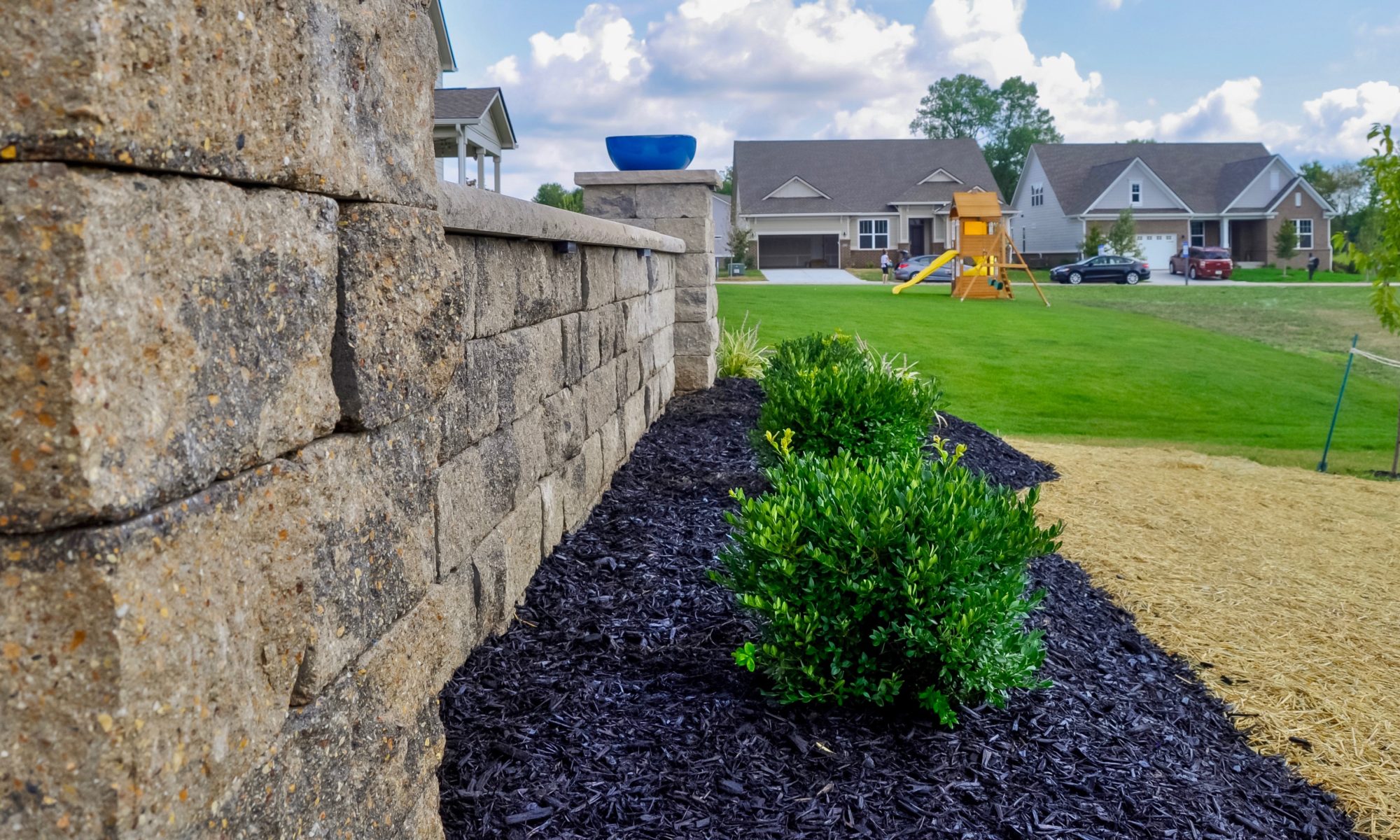 Precision Outdoors Noblesville Paver Patio paver patio raised gathering space backyard natural blended lights safe clear visibility night raised retaining wall limestone rock materials trim endcaps landscaping mulch installation straw seed placement unblock beacon hill smooth pavers opal hollandstone charcoal color accents estate wall materials alpine grey indiana entertaining space gathering