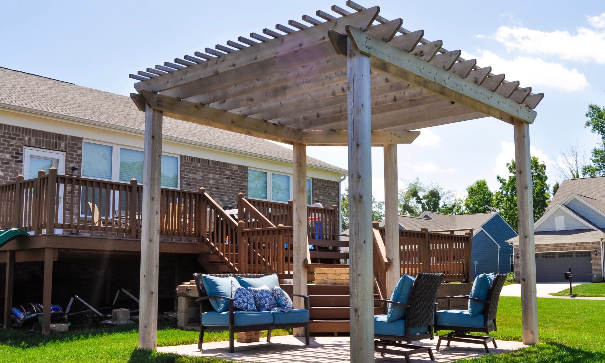 Precision Outdoors Fishers Pergola & Firepit cedar pergola structure firm paver patio beggar lafitt rustic slab Danville beige color accents wrap around firepit bench seating kids play area slide built in built-in deck sandbox play pad surrounding swing set area fishers indiana playground