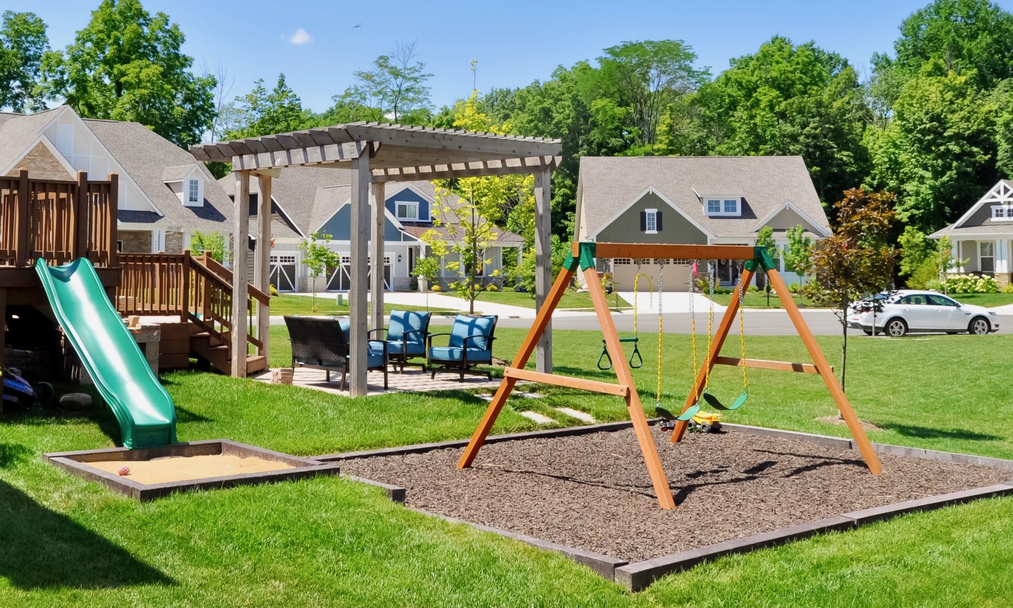 Precision Outdoors Fishers Pergola & Firepit cedar pergola structure firm paver patio beggar lafitt rustic slab Danville beige color accents wrap around firepit bench seating kids play area slide built in built-in deck sandbox play pad surrounding swing set area fishers indiana playground