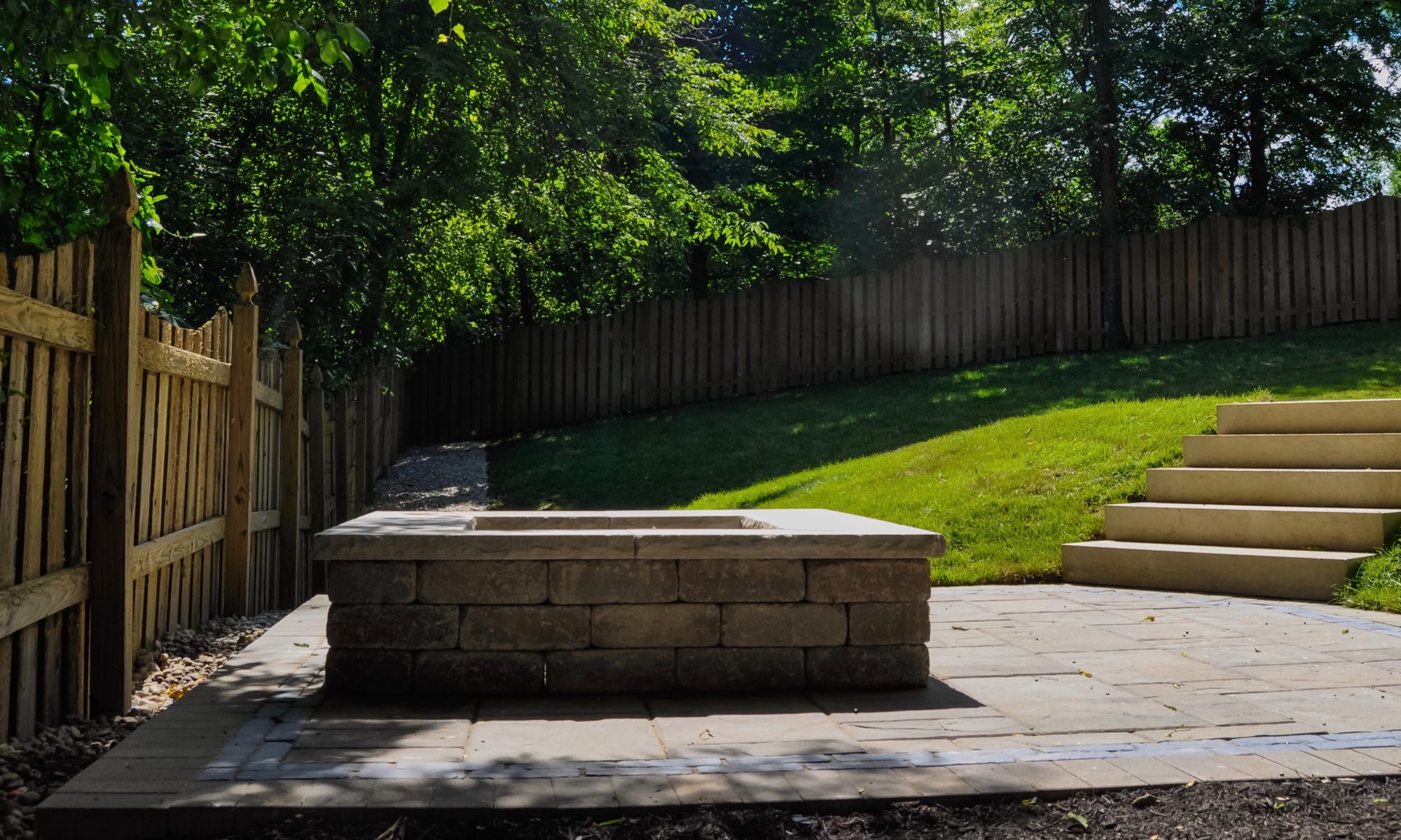 Precision Outdoors Fishers Paver Patio yard encompassing paver patio belgard lafitt material cotswald mist charcoal trim block firepit fire pit paved space quaint stairs porch bridge landing step landscaping mulching fishers indiana