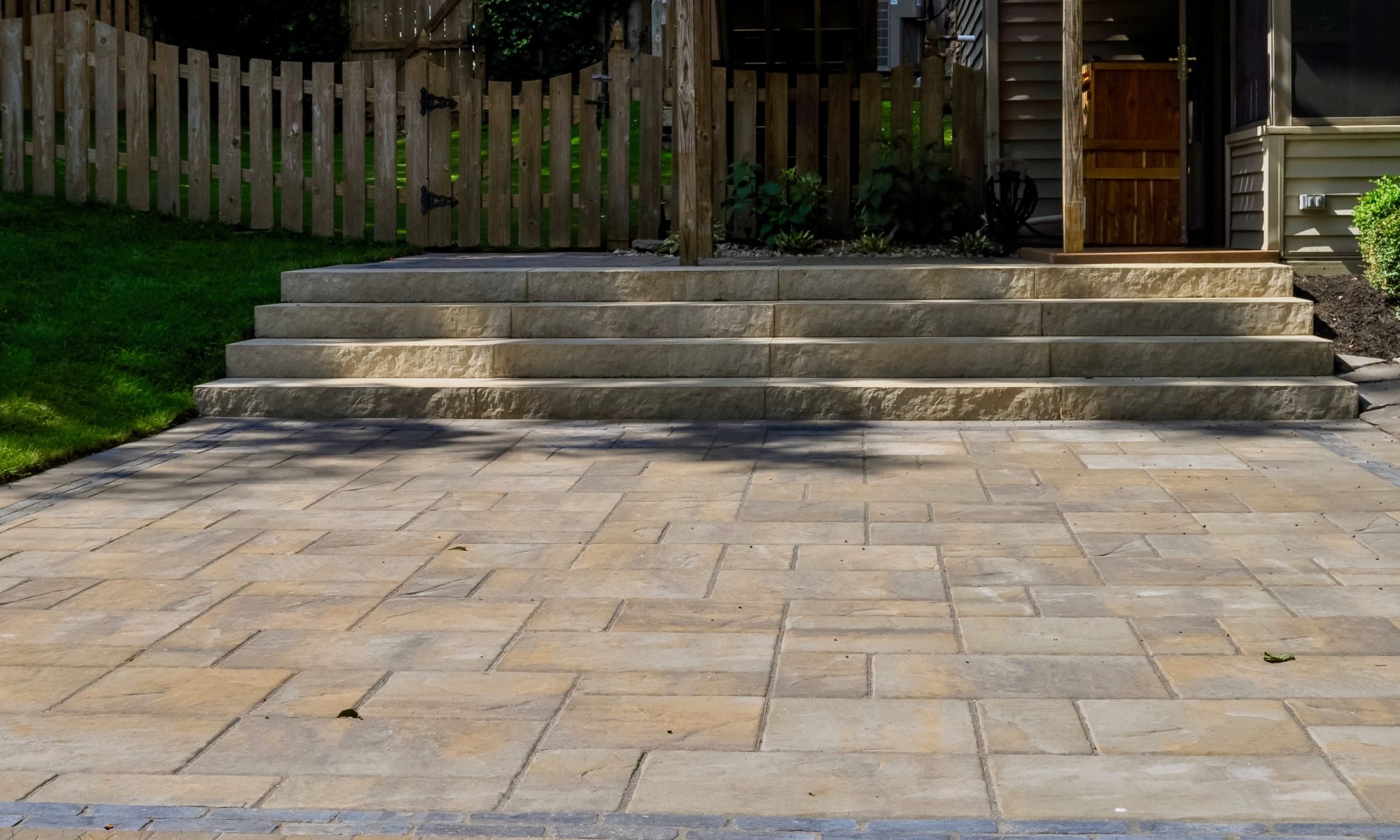 Precision Outdoors Fishers Paver Patio yard encompassing paver patio belgard lafitt material cotswald mist charcoal trim block firepit fire pit paved space quaint stairs porch bridge landing step landscaping mulching fishers indiana