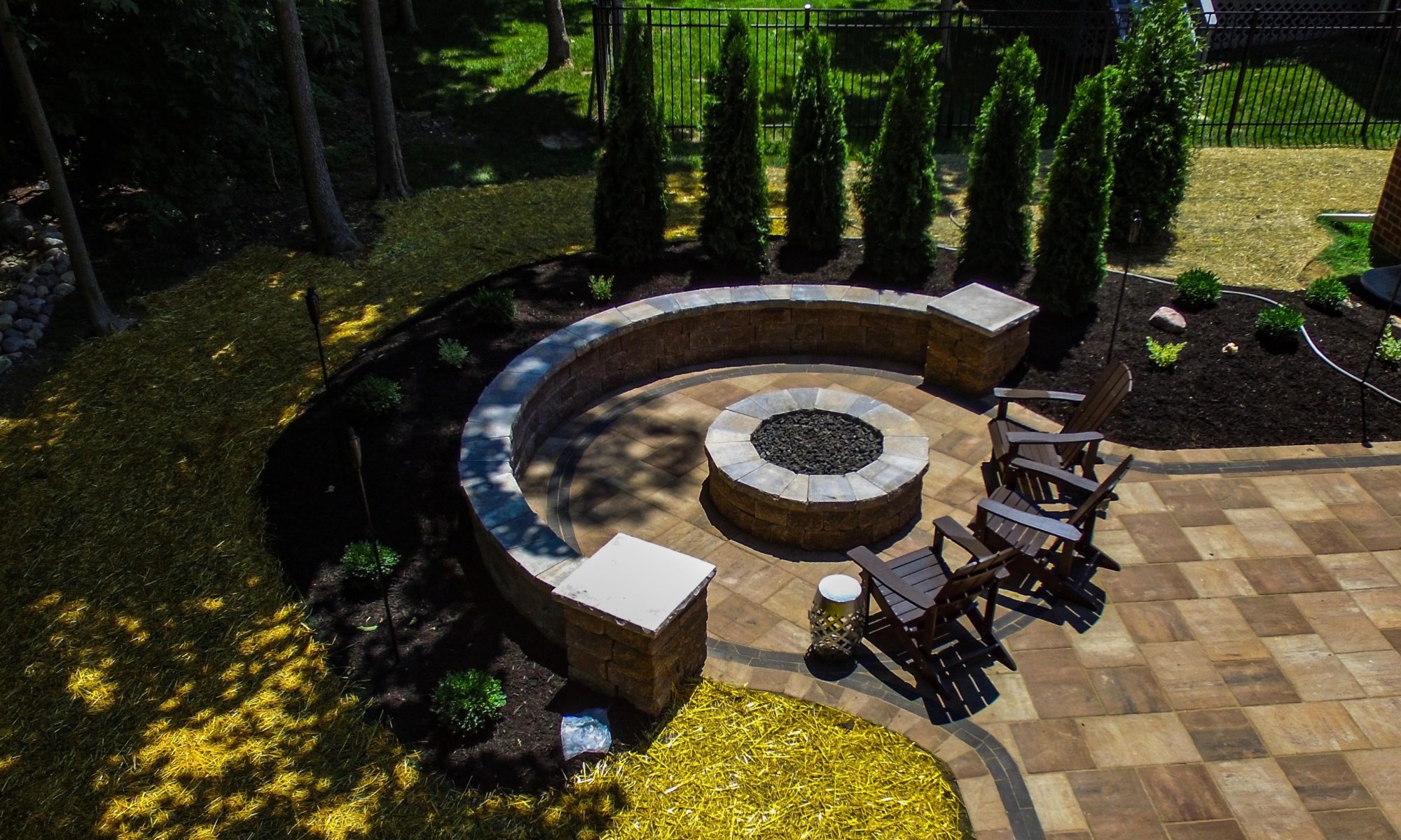 Precision Outdoors Fire Pit Indianapolis Indiana Exterior Design Outdoor Living Unilock Firepit fire pit belgard lafitt rustic slab paver patio beige and Ashbury haze color ways charcoal moduline accents custom gas fire pit wrap around seating wall Greenwood indiana