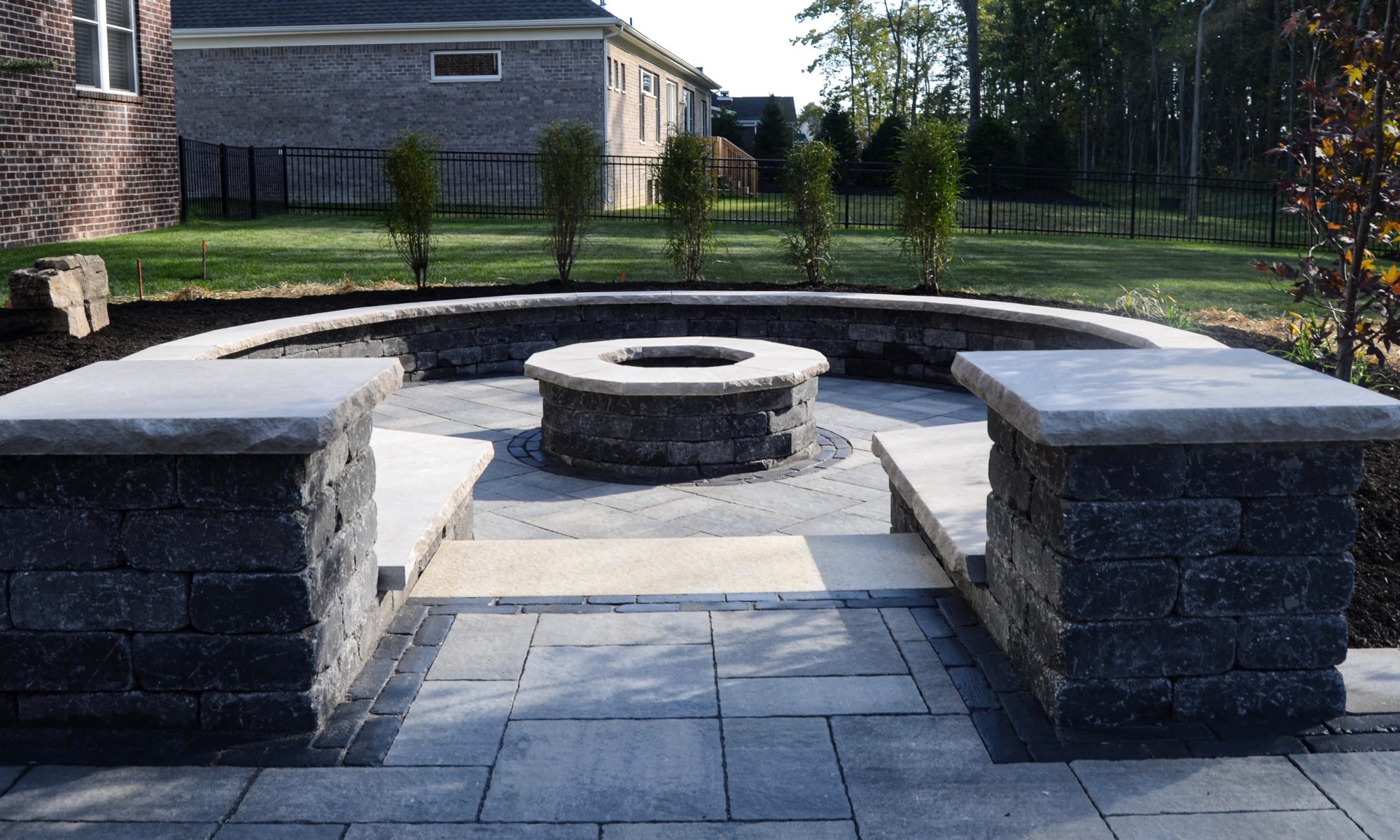 Precision Outdoors Zionsville Fire Pit & Patio custom paver patio gathering space backyard sunken fire pit landscaping mulching straw and seed placement unblock Bristol valley steel mountain Copthorne accents seating wall belgard round fire pit Firepit Weston wall rock face limestone caps zionsville indiana privacy