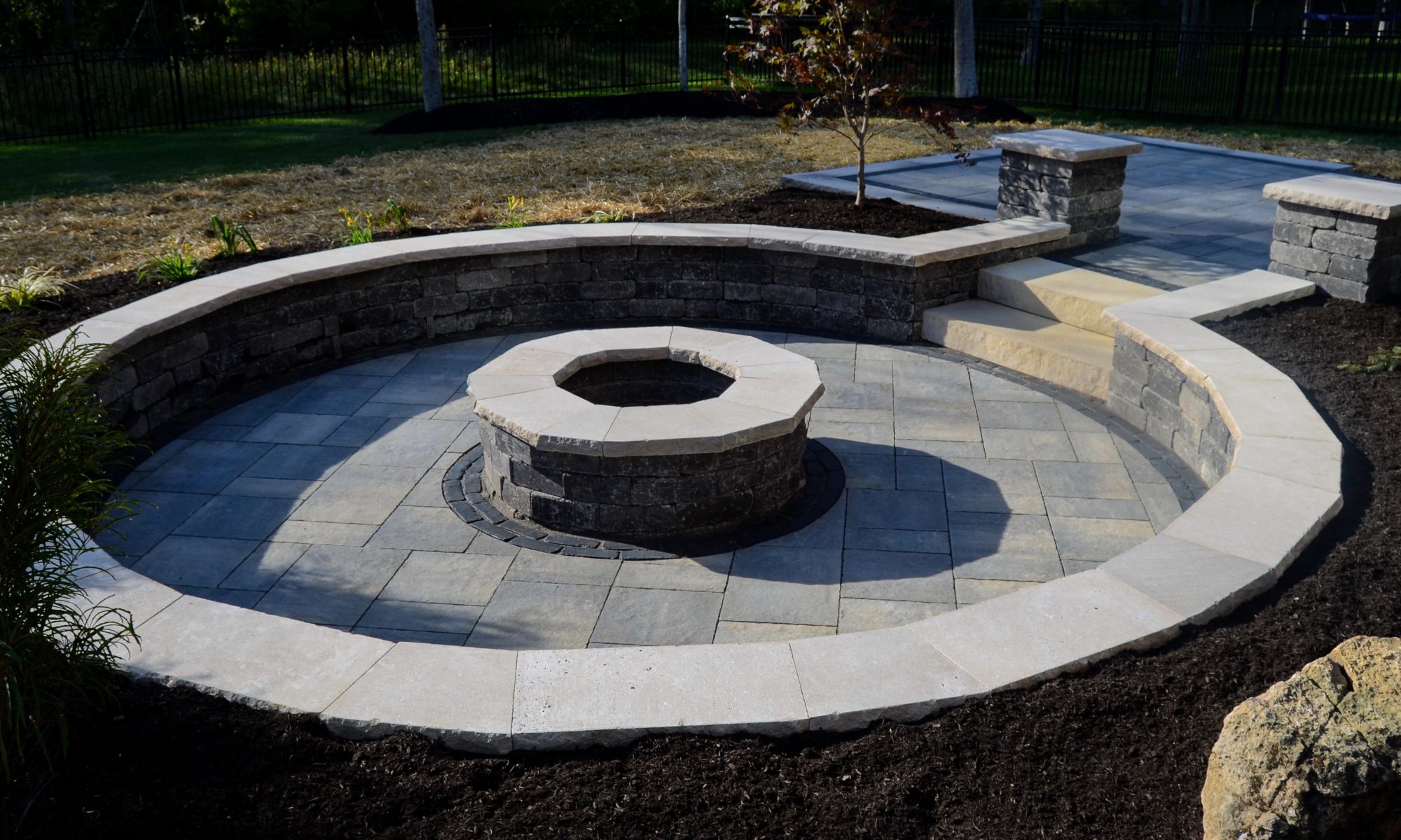 Precision Outdoors Zionsville Fire Pit & Patio custom paver patio gathering space backyard sunken fire pit landscaping mulching straw and seed placement unblock Bristol valley steel mountain Copthorne accents seating wall belgard round fire pit Firepit Weston wall rock face limestone caps zionsville indiana privacy