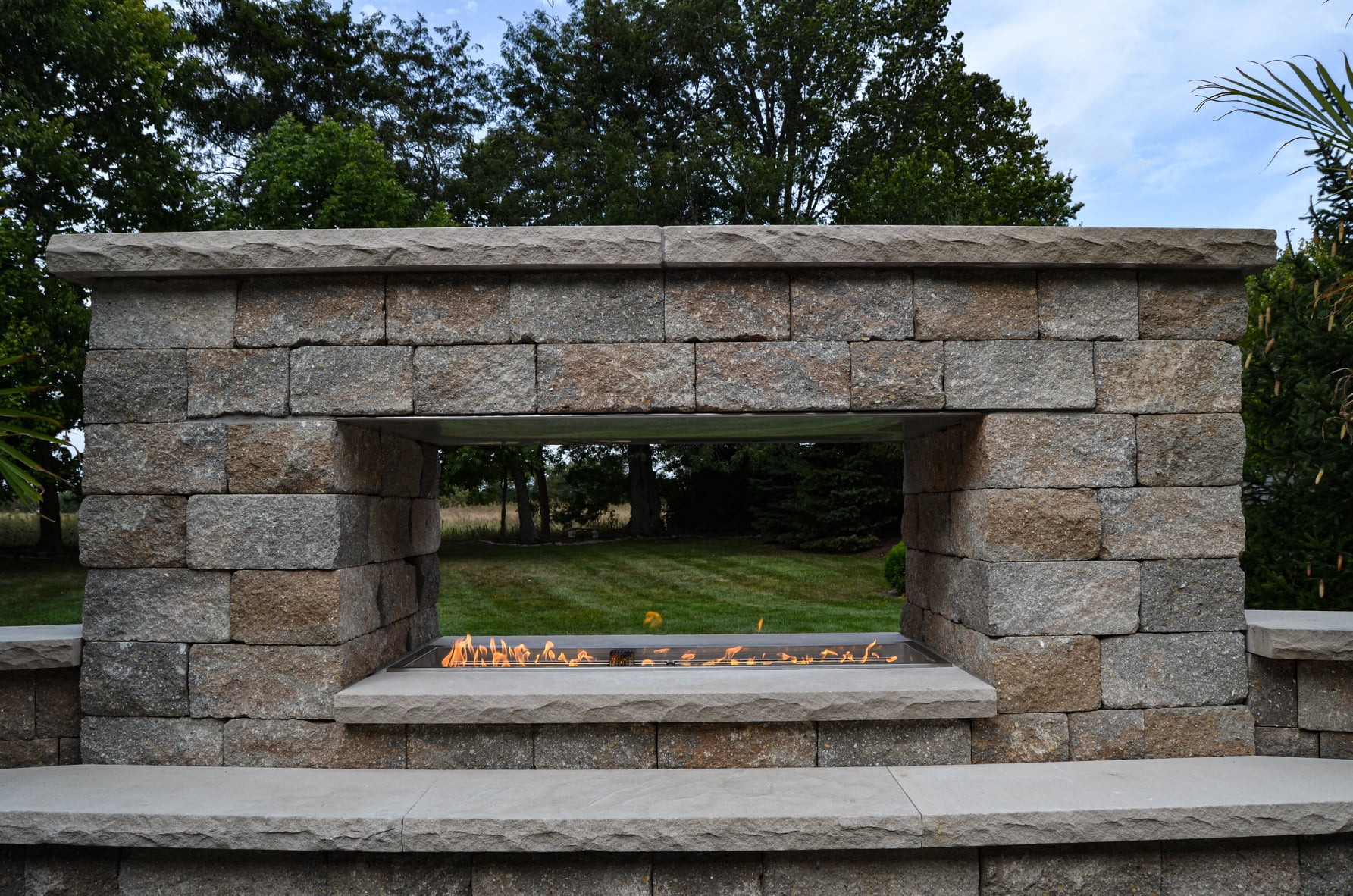 Precision Outdoors Greenwood Fireplace & patio custom paver patio secluded gathering space backyard dual fireplace gathering landscaping, mulching, straw and seed placement seeding unilock materials Greenwood indiana dream space