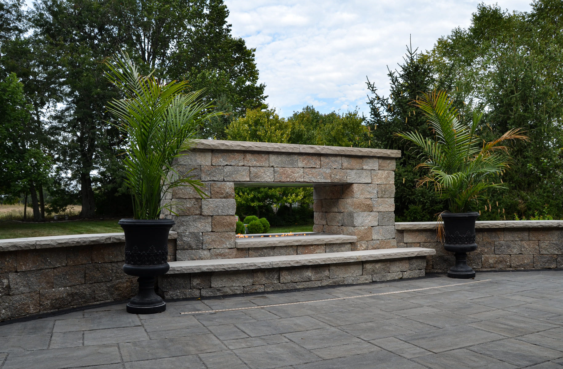 Precision Outdoors Greenwood Fireplace & patio custom paver patio secluded gathering space backyard dual fireplace gathering landscaping, mulching, straw and seed placement seeding unilock materials Greenwood indiana dream space