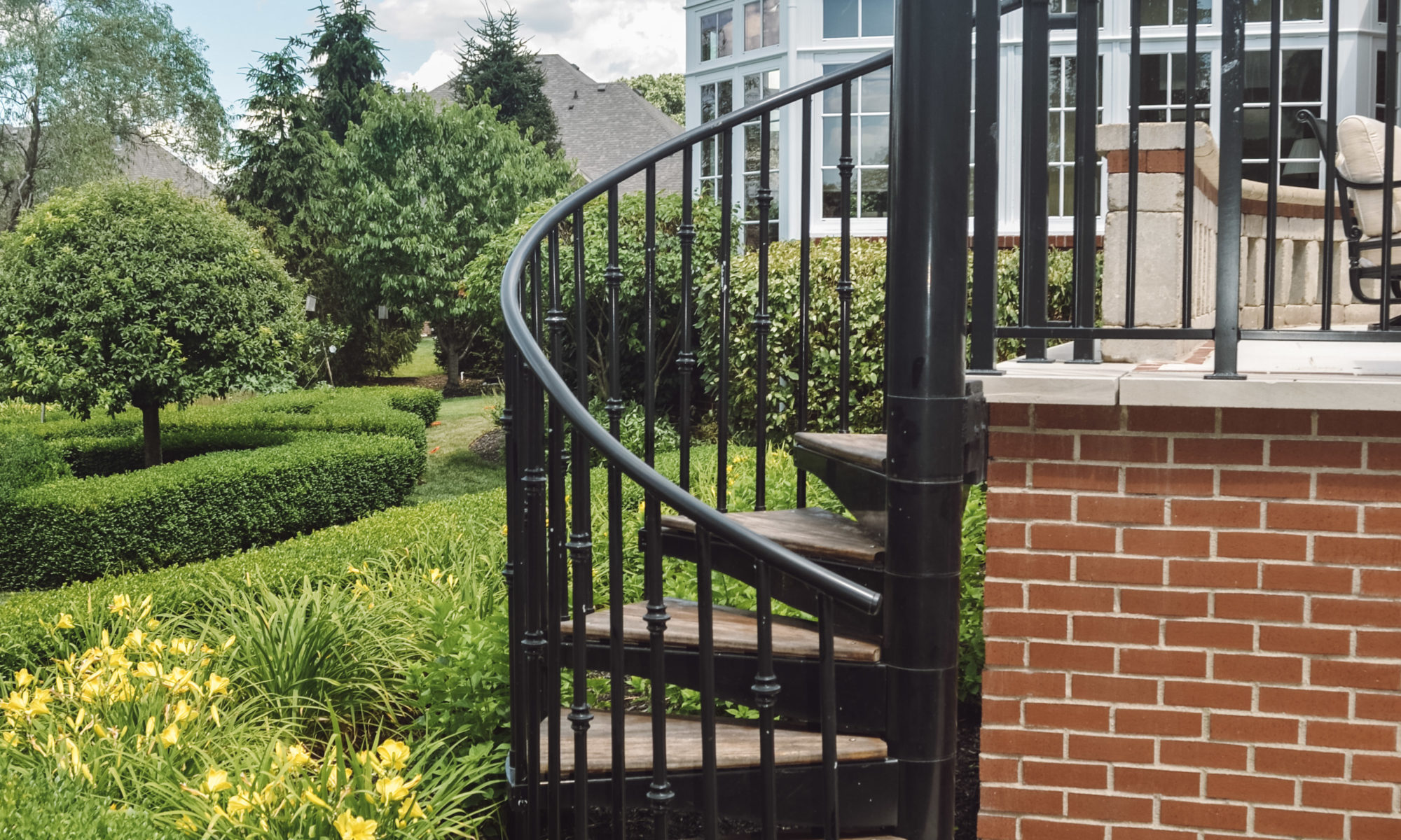 Precision Outdoors English Garden Overlook spiral stairs custom railing dining seating hosting custom patio brick retaining wall greenwood indiana patio