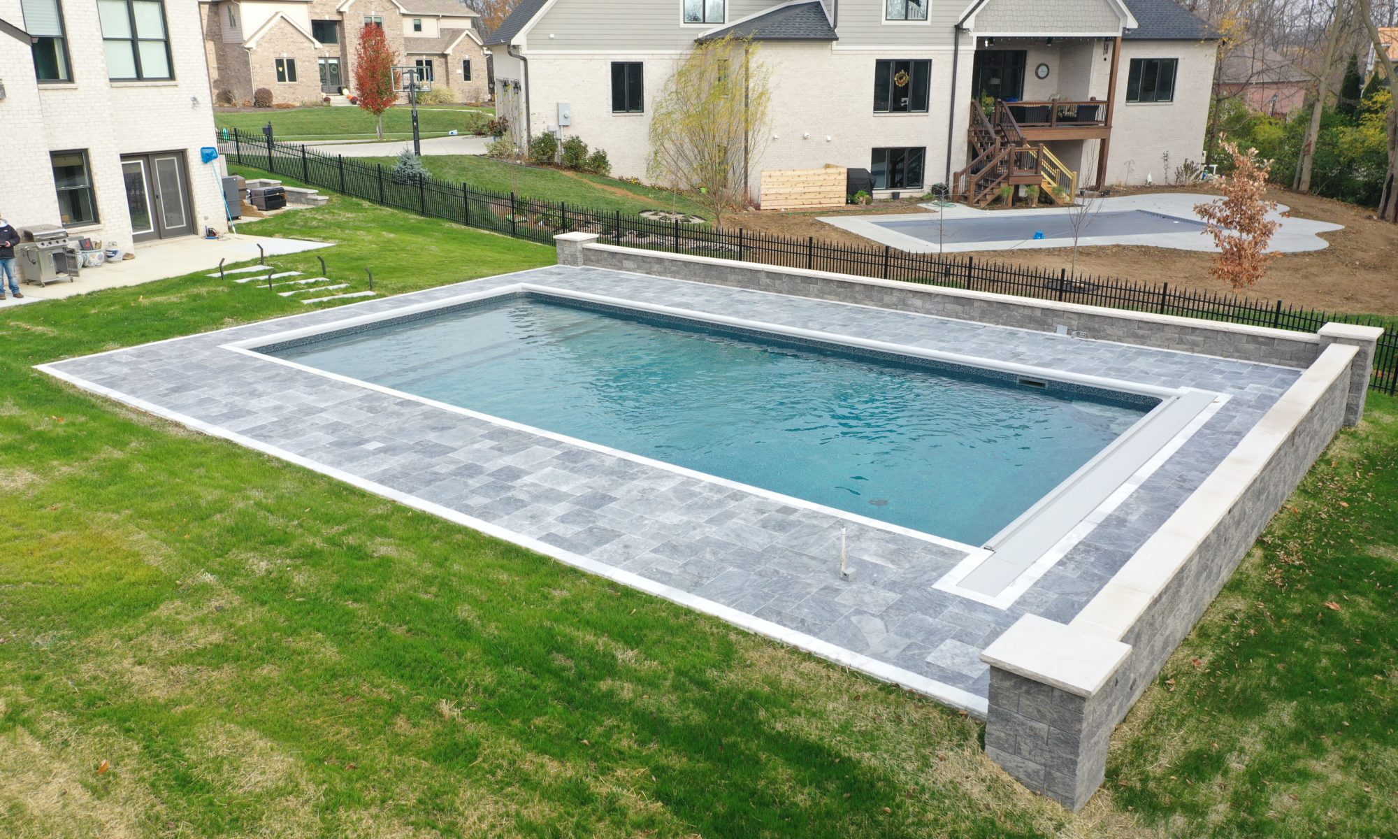 Precision Outdoors Travertine Pool Deck retaining wall limestone caps walkway path lights indianapolis indiana oberfield travertine ice marble accent strip overfilled versalok versa-lok granite blend taho marble