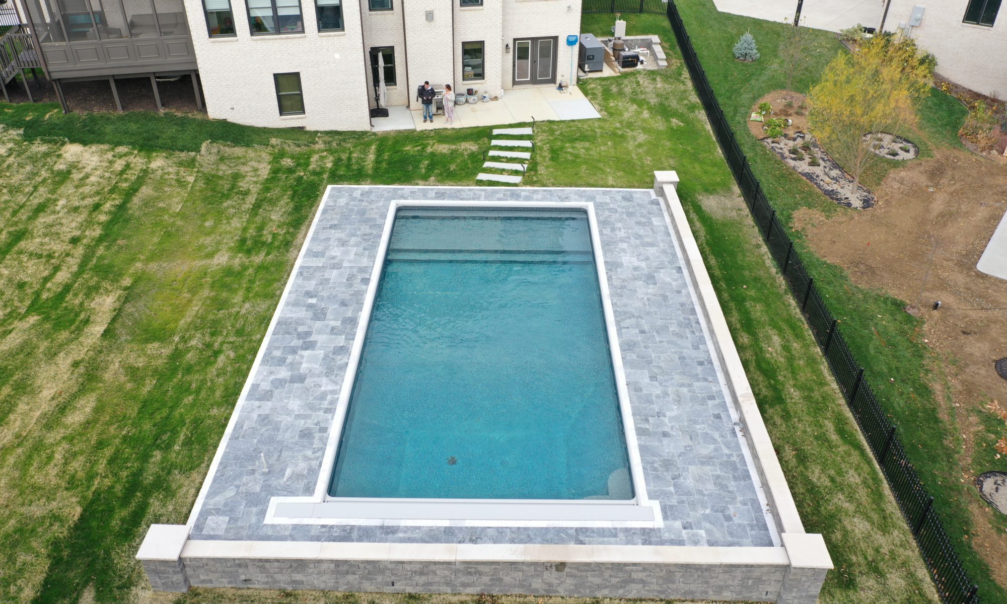 Precision Outdoors Travertine Pool Deck retaining wall limestone caps walkway path lights indianapolis indiana oberfield travertine ice marble accent strip