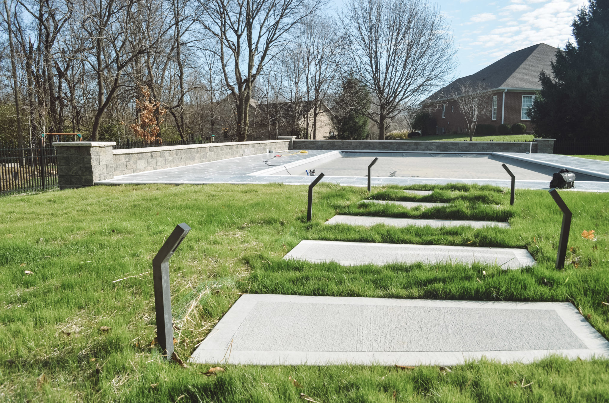 Precision Outdoors Travertine Pool Deck retaining wall limestone caps walkway path lights indianapolis indiana oberfield travertine ice marble accent strip overfilled versalok versa-lok granite blend taho marble