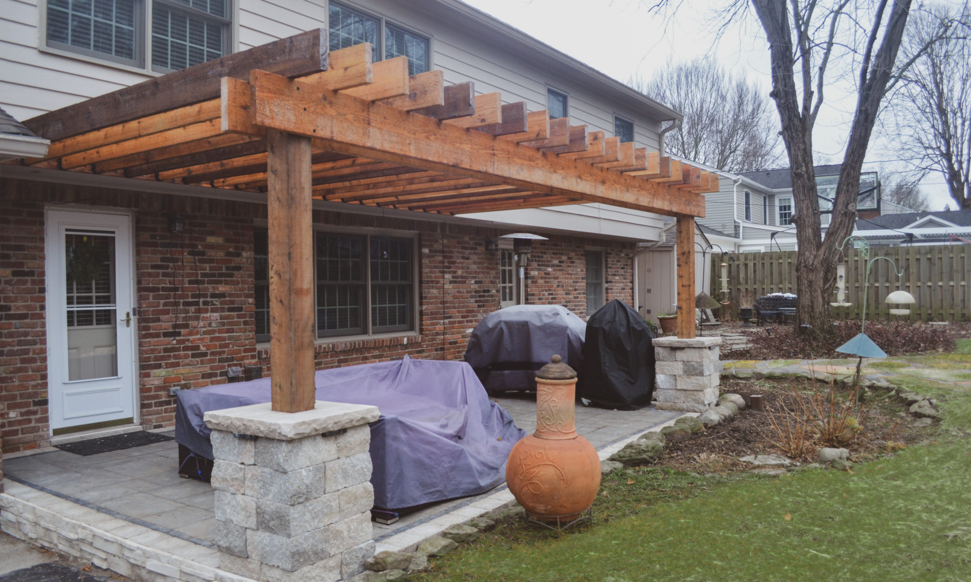 Precision Outdoors Flagstone patio and pergola cedar pergola small boulder firepit fire pit flagstone patio unlock paver patio indianapolis indiana