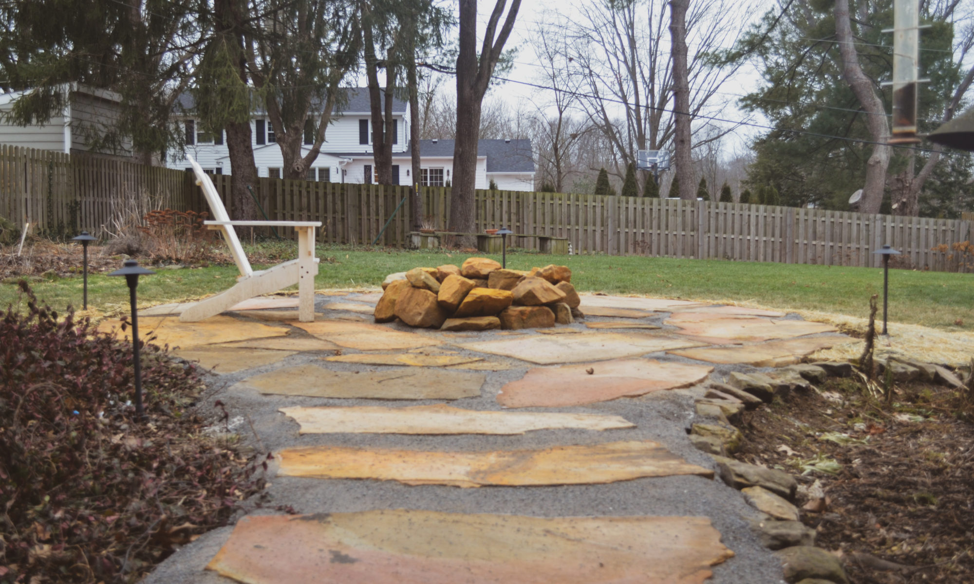 Precision Outdoors Flagstone patio and pergola cedar pergola small boulder firepit fire pit flagstone patio unlock paver patio indianapolis indiana