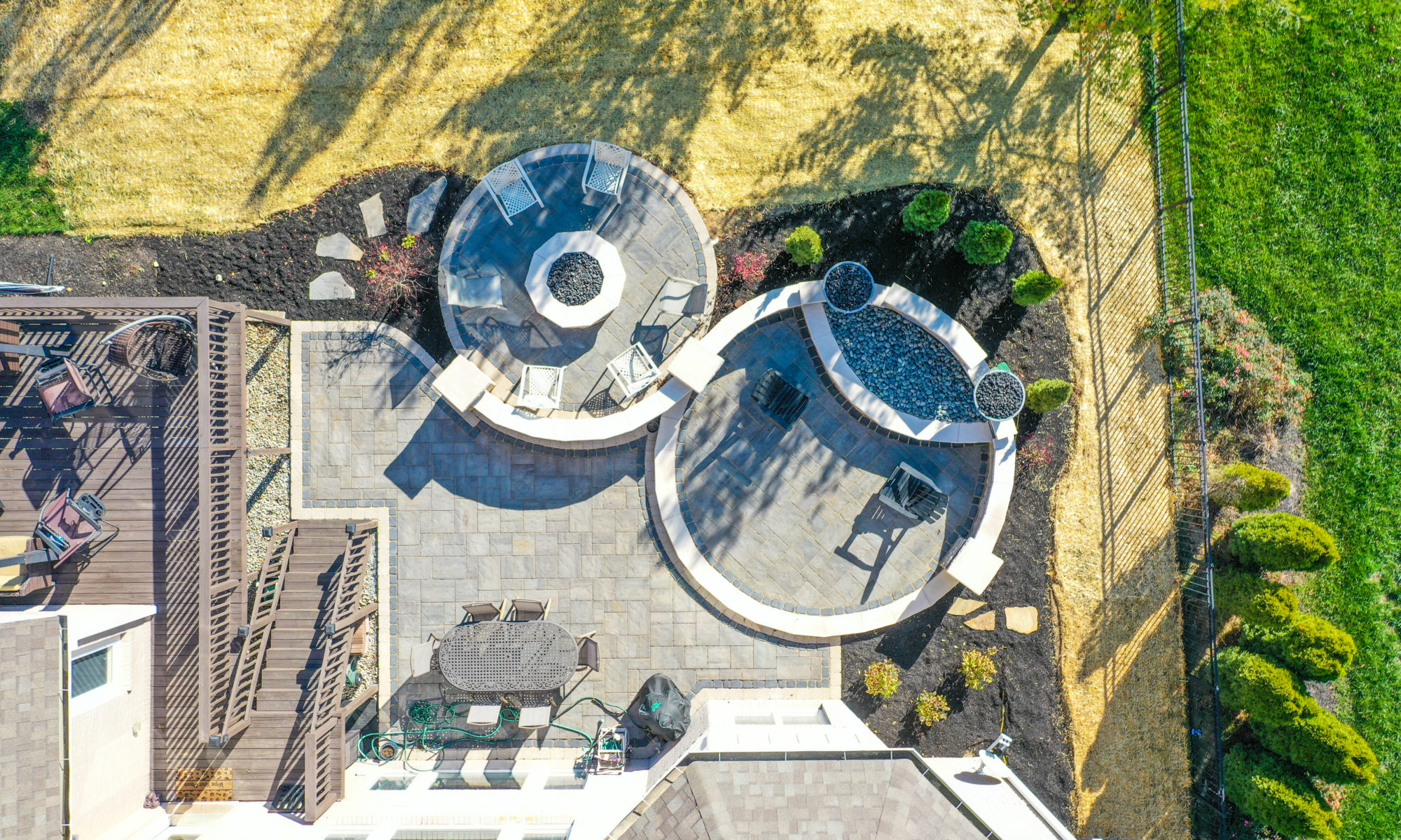 Precision Outdoor Curves of Fire gas firepit water feature two gas fire bowls unlock paver patio beacon hill flagstone alpine grey custom landscaping Noblesville indiana