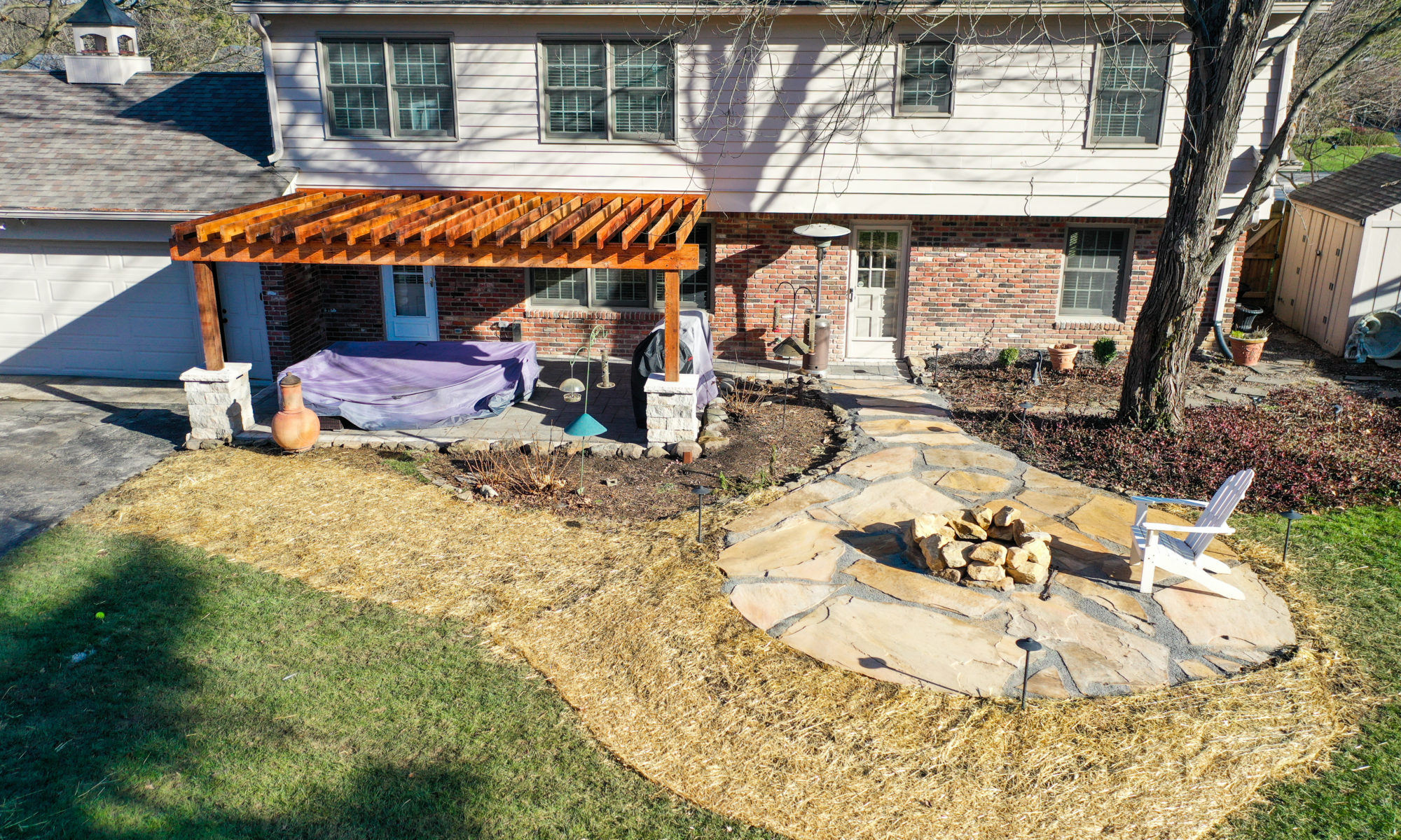 Precision Outdoors Flagstone patio and pergola cedar pergola small boulder firepit fire pit flagstone patio unlock paver patio indianapolis indiana