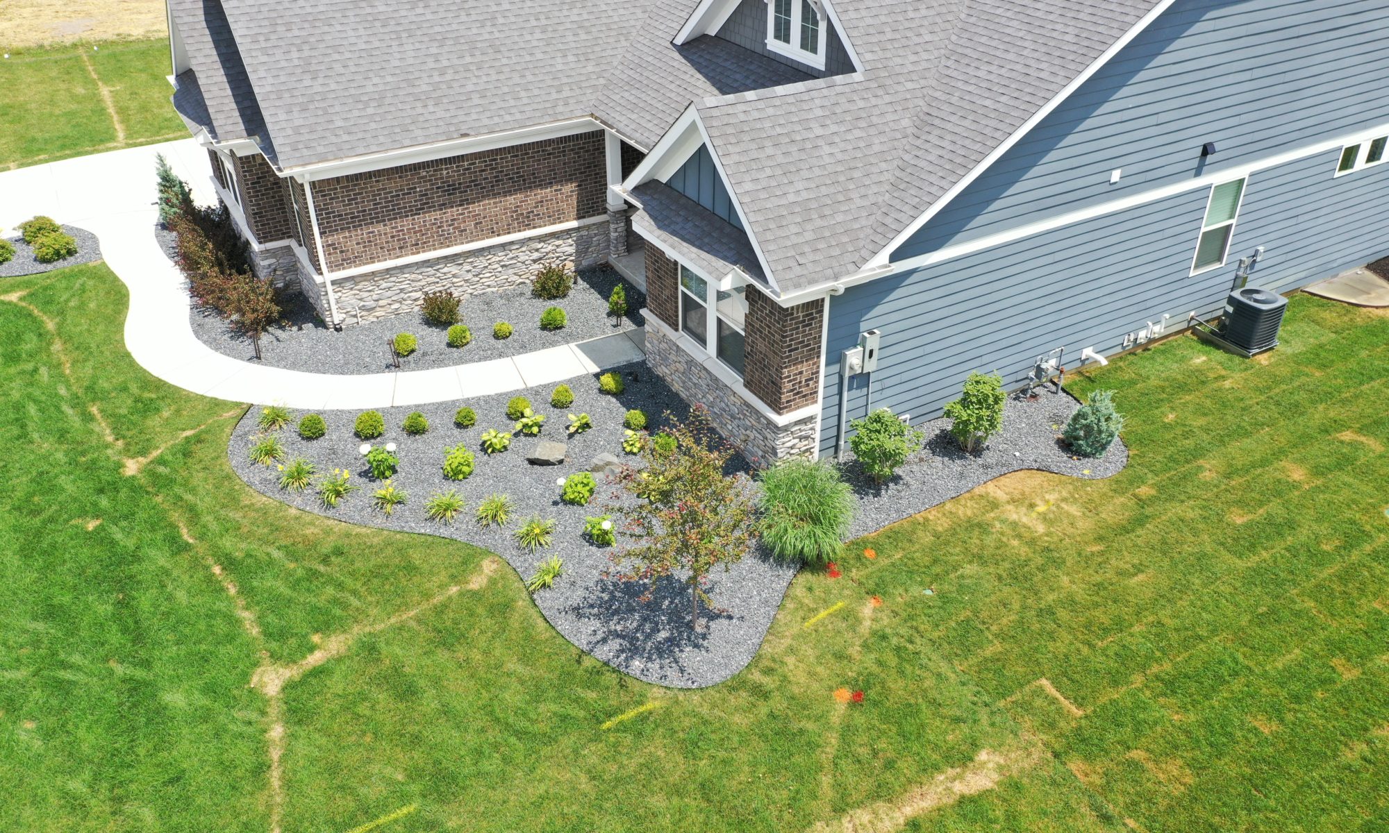 poolside pavillion paver patio pool fire fireplace stairs cover gray grey tanning deck graven plants trees flowers black
