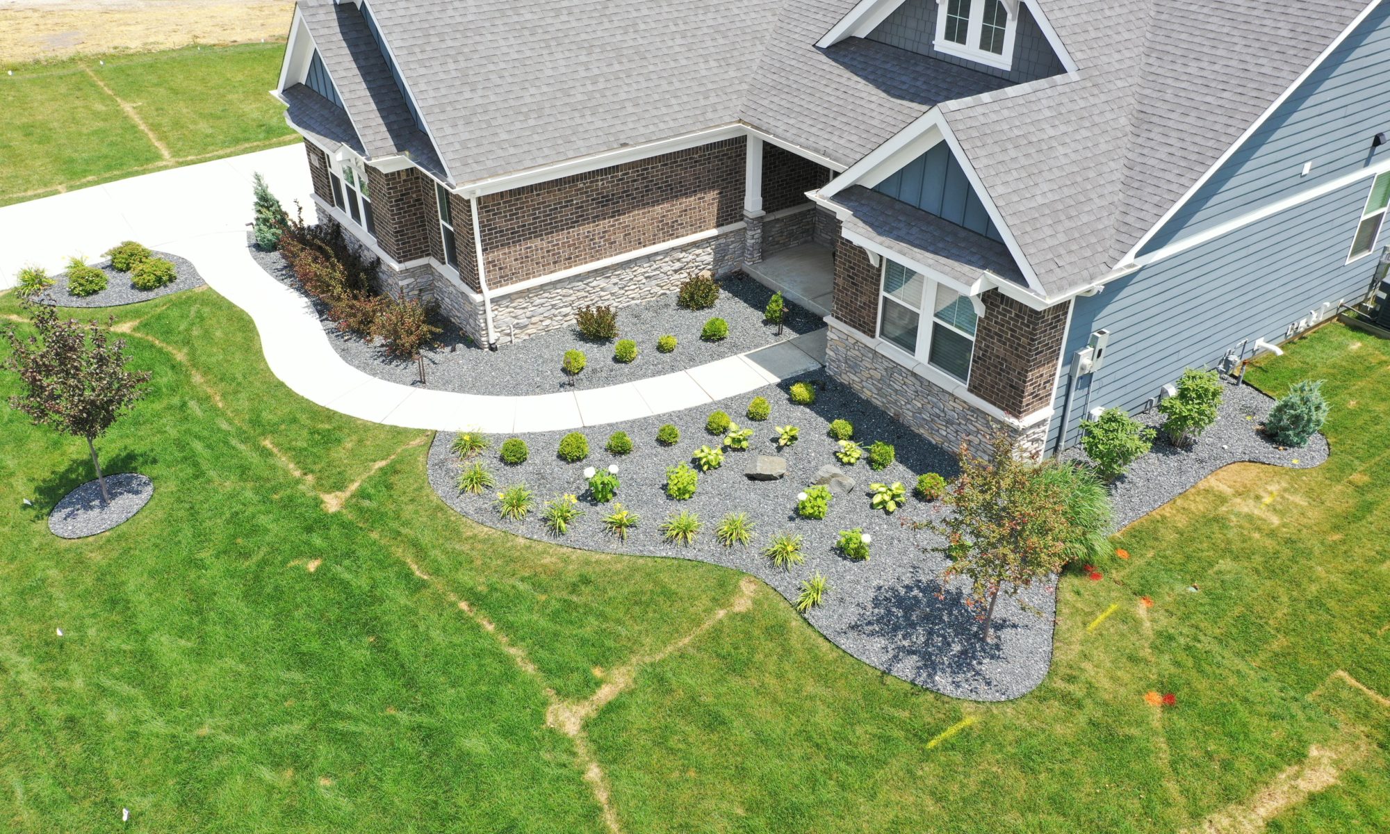 poolside pavilion paver patio pool fire fireplace stairs cover gray grey tanning deck graven plants trees flowers black