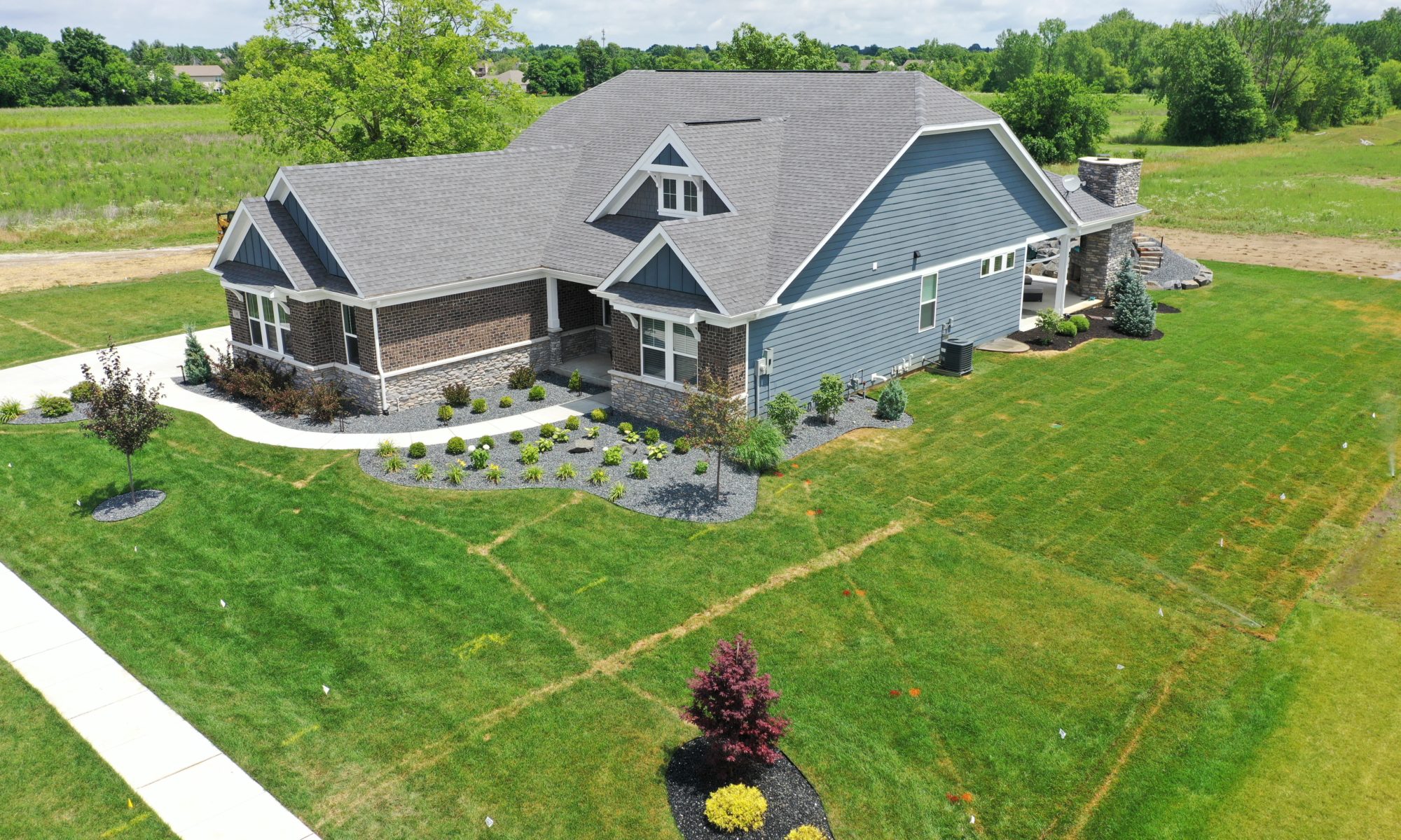 poolside pavillion paver patio pool fire fireplace stairs cover gray grey tanning deck graven plants trees flowers black
