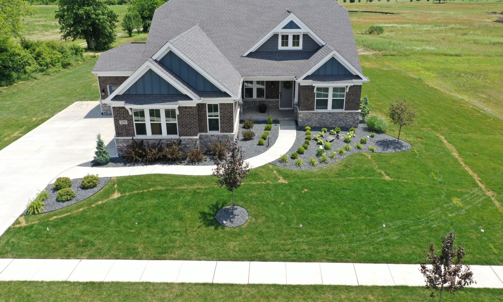 poolside pavilion paver patio pool fire fireplace stairs cover gray grey tanning deck graven plants trees flowers black