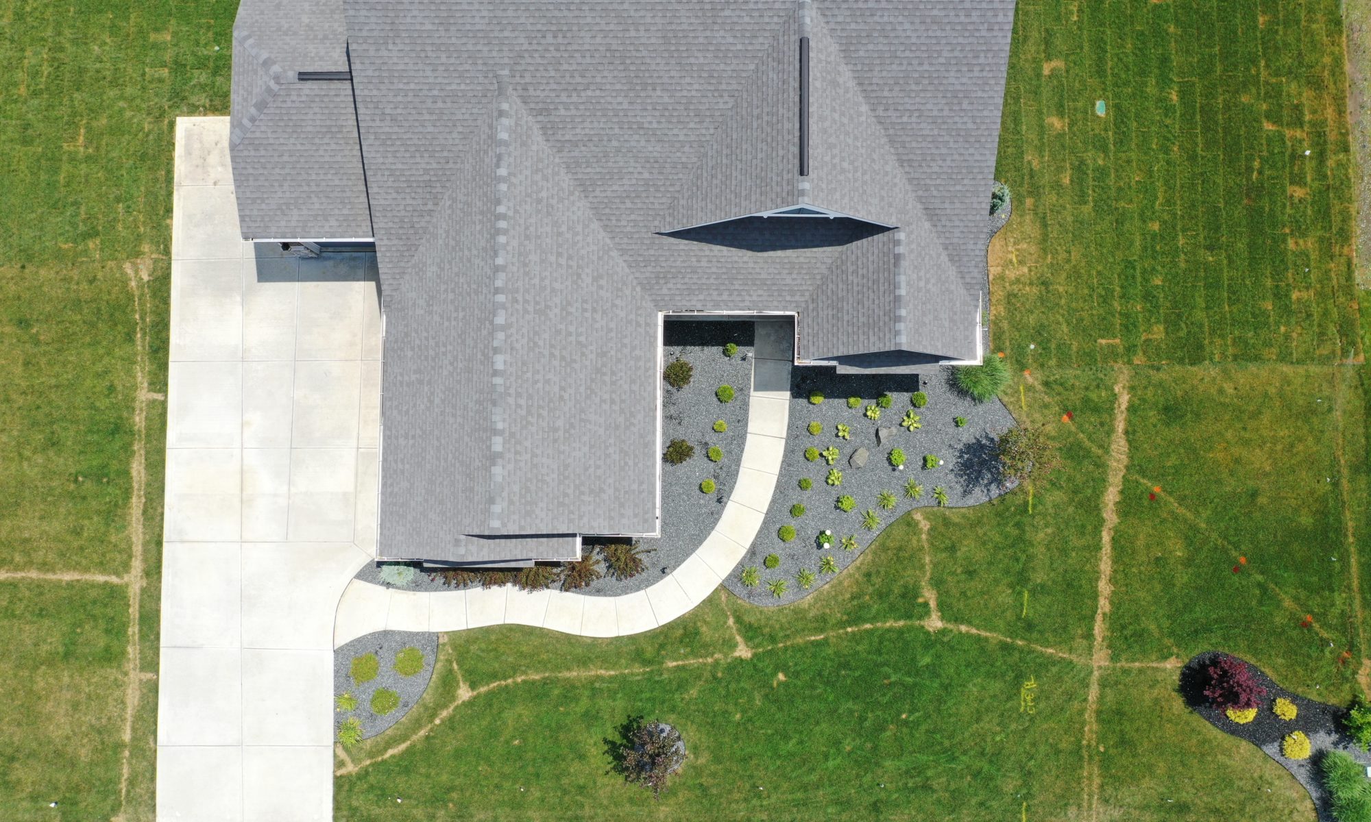 poolside pavillion paver patio pool fire fireplace stairs cover gray grey tanning deck graven plants trees flowers black