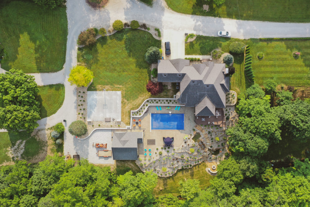 Precision Outdoors the epic waterfall rocks boulders stairs outdoor dream backyard fire pit pool waterfall indianapolis indiana seating wall amazing basketball court landscaping