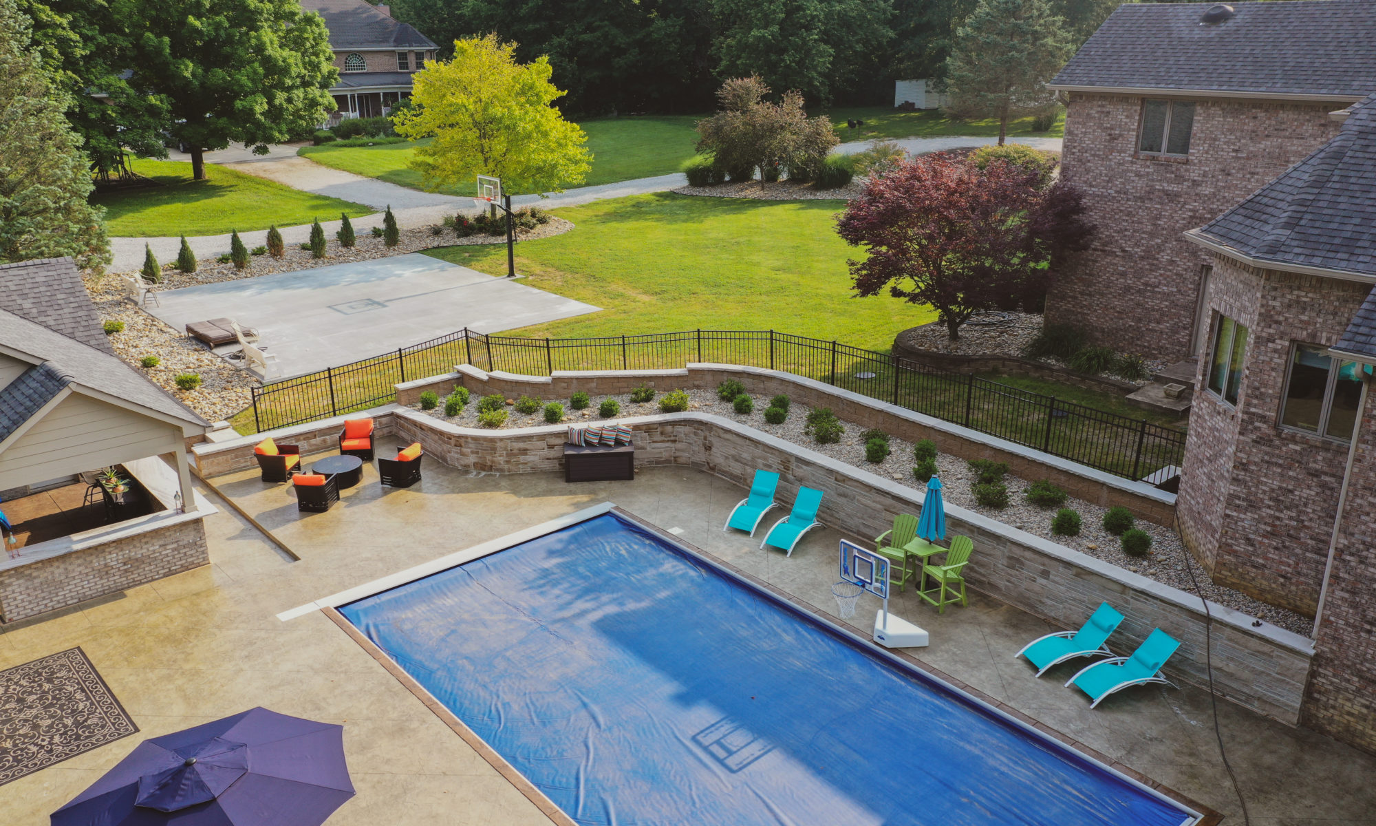 Precision Outdoors the epic waterfall rocks boulders stairs outdoor dream backyard fire pit pool waterfall indianapolis indiana seating wall amazing basketball court landscaping