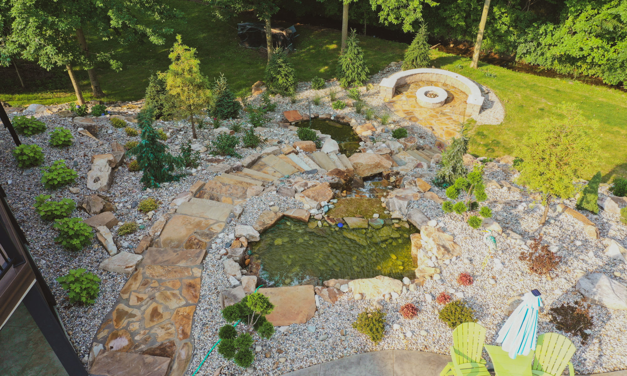 Precision Outdoors the epic waterfall rocks boulders stairs outdoor dream backyard fire pit pool waterfall indianapolis indiana seating wall amazing basketball court landscaping