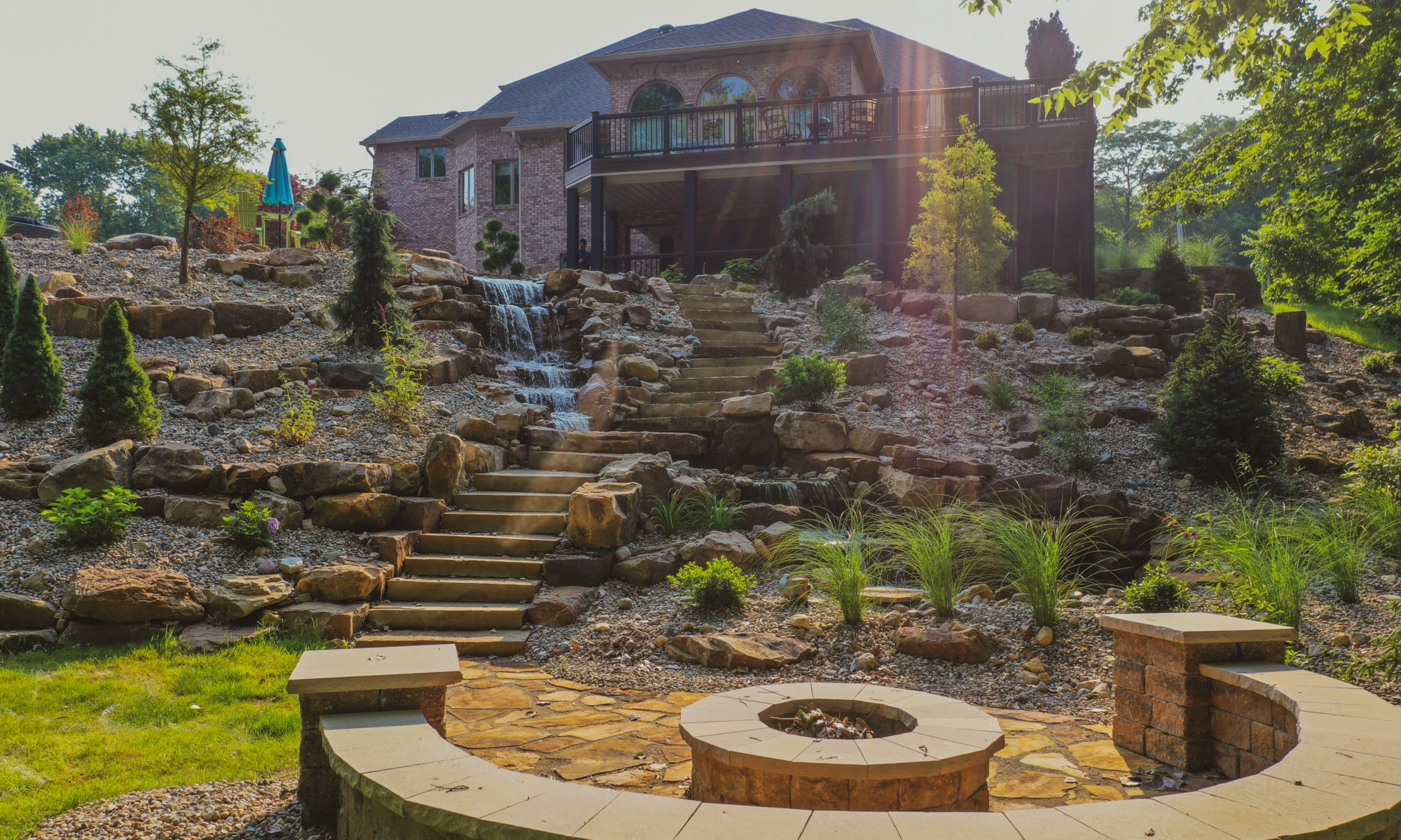 Precision Outdoors the epic waterfall rocks boulders stairs outdoor dream backyard fire pit pool waterfall indianapolis indiana seating wall amazing basketball court landscaping