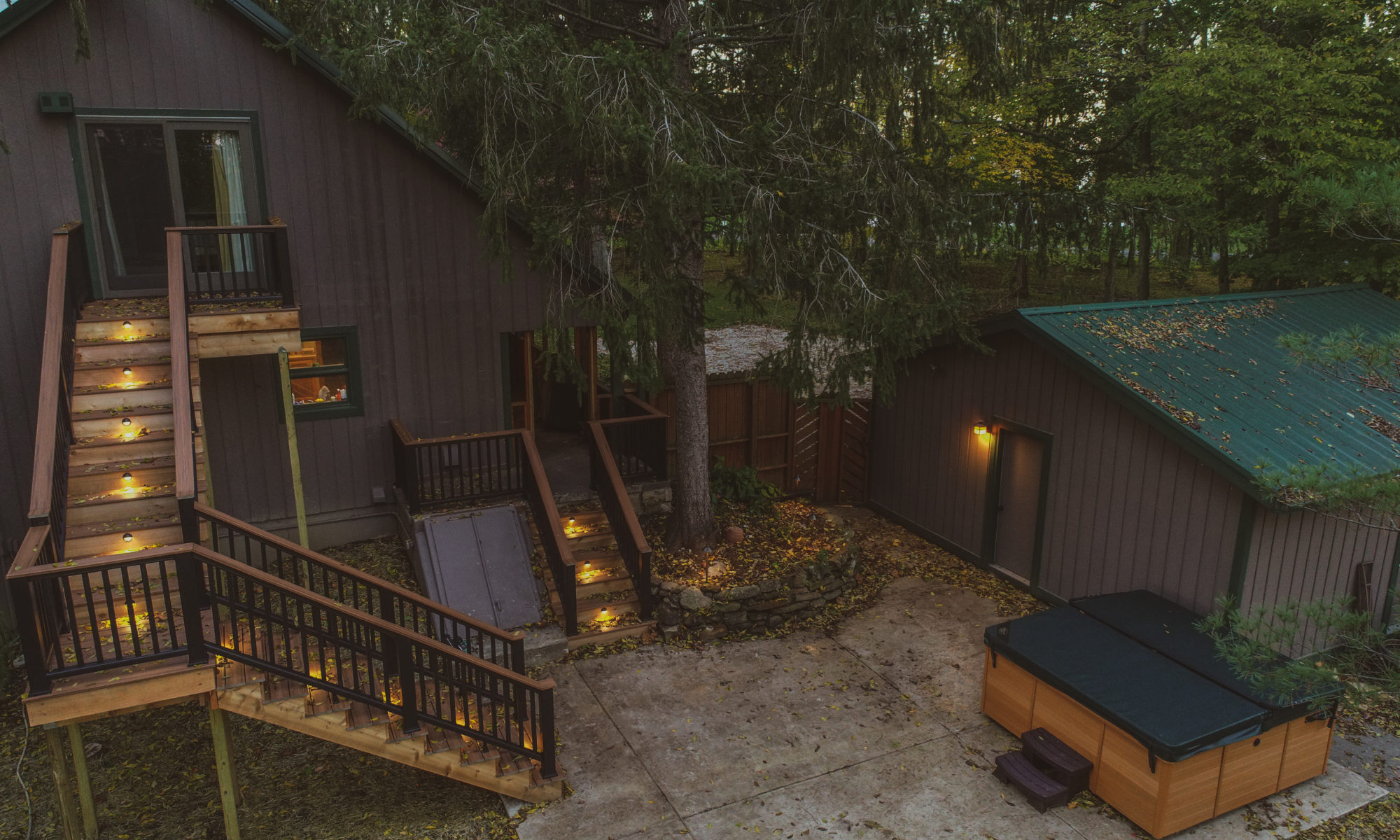 Countryside Backyard precision outdoors design build stairs railing custom concrete patio deck log cabin home hot tub house hottub lighting night lit