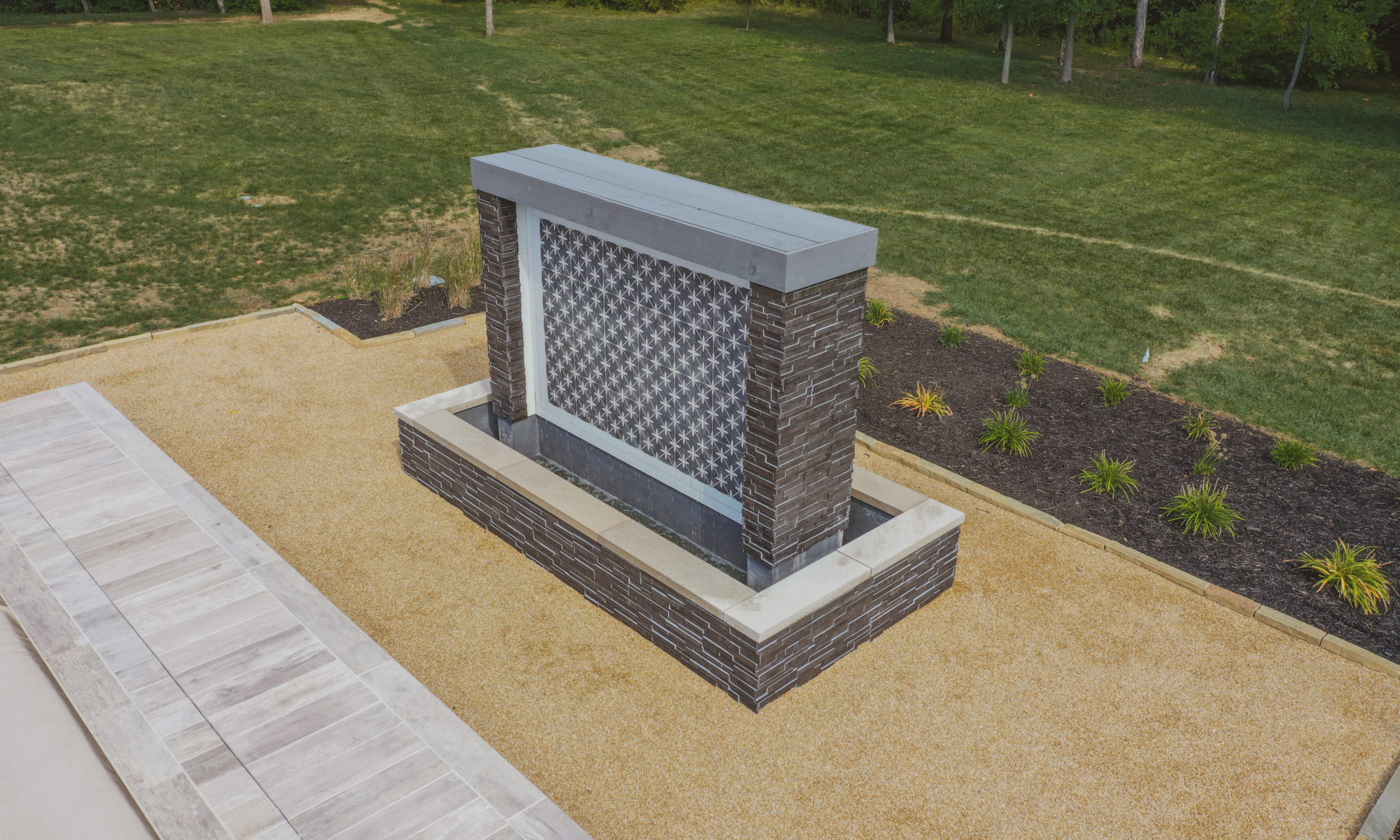 Precision Outdoors Carmel Art Silo Deck custom water feature outdoor living by Belgard noon tile pool deck custom landscaping Carmel indiana dream backyard goals