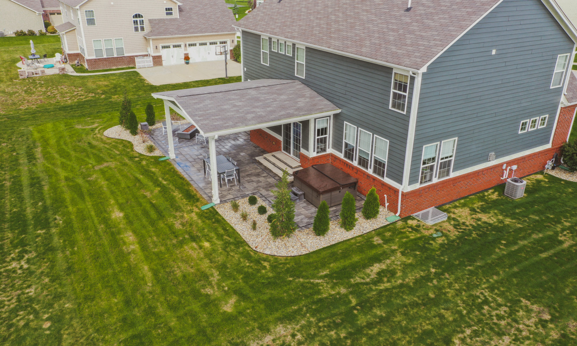 Precision Outdoors Classic Paver and firepit gable roof structure linear gas firepit paver patio custom landscaping Greenwood Indiana