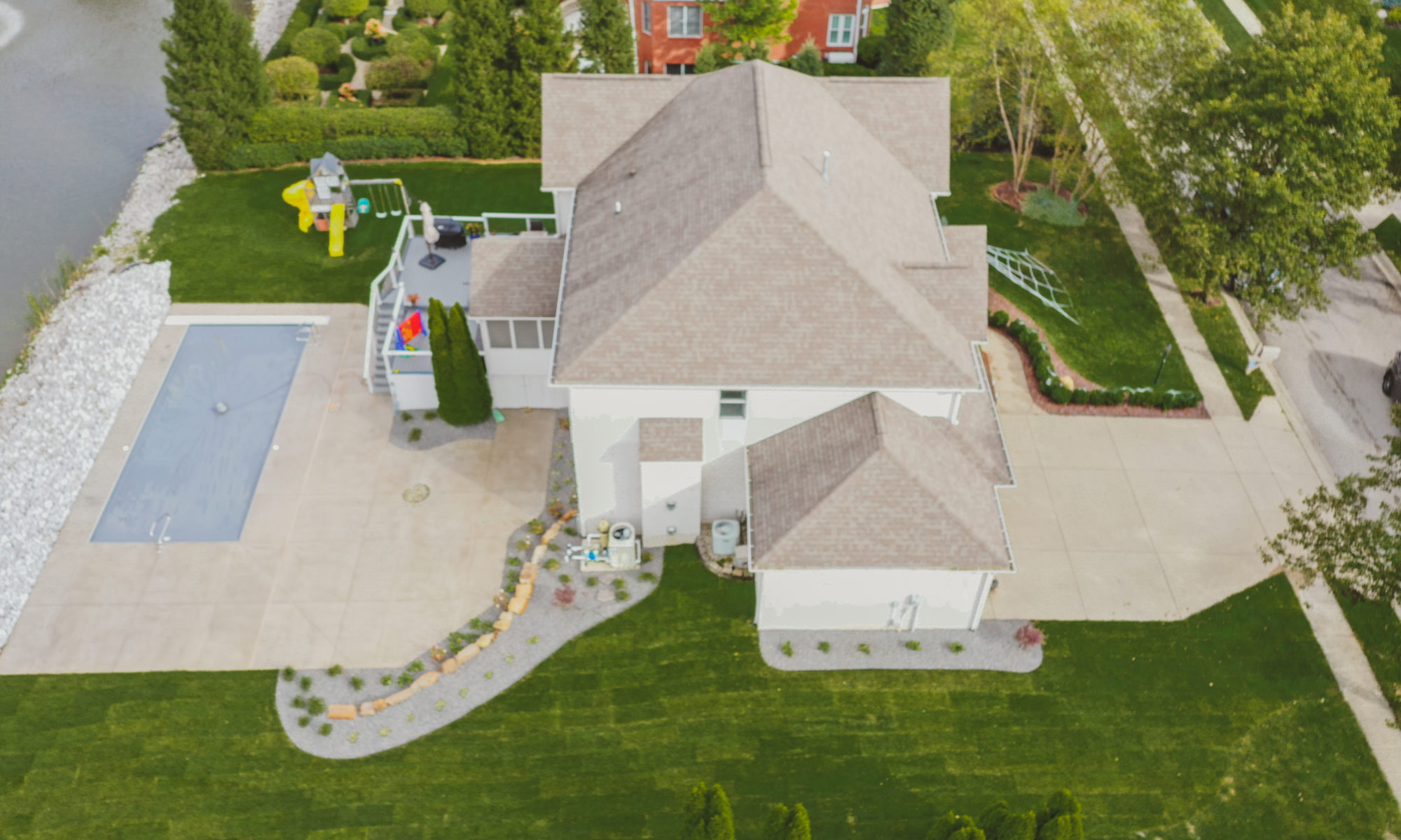 Precision Outdoors Poolside Landscaping Project Custom landscaping plants shrubs small boulders indianapolis Indiana dream backyard