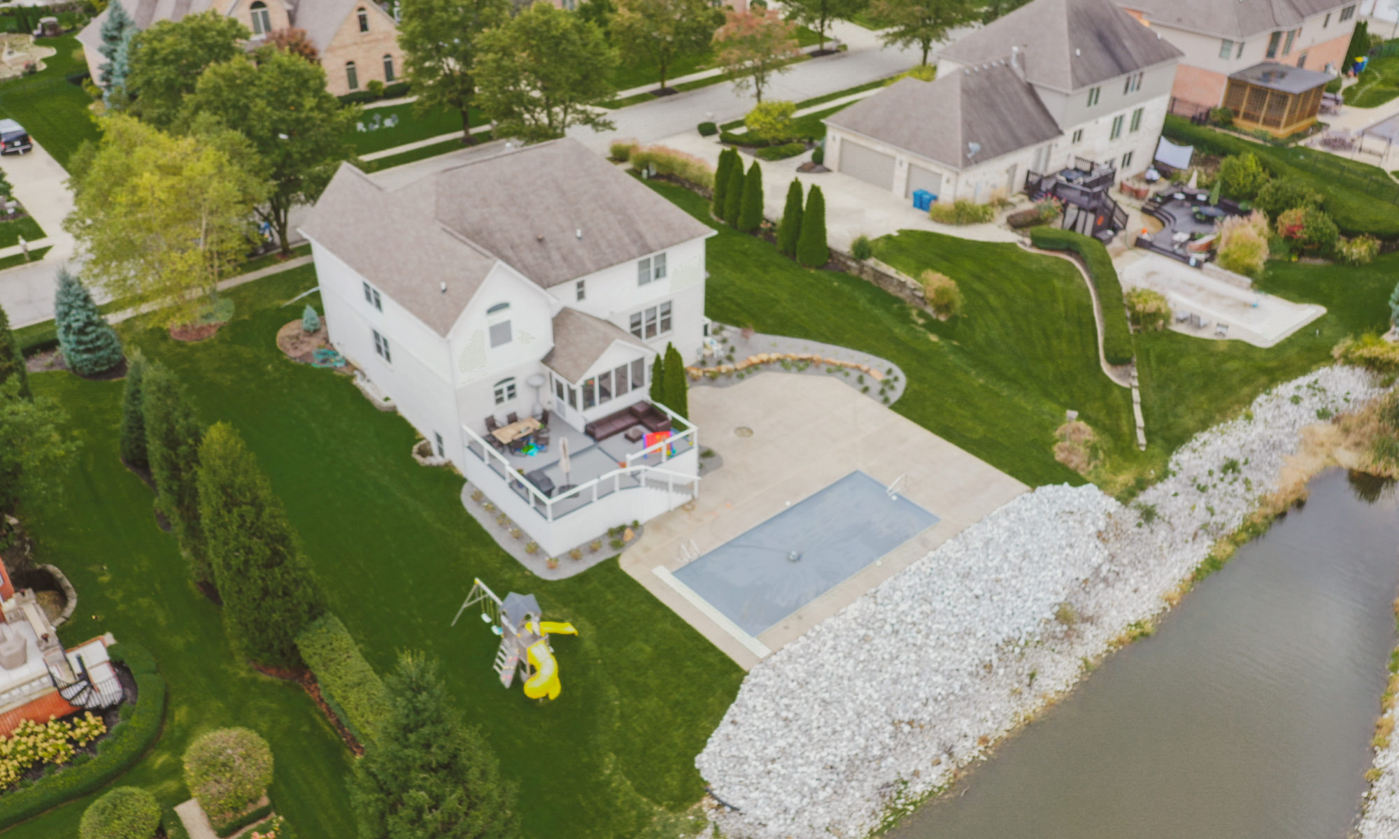 Precision Outdoors Poolside Landscaping Project Custom landscaping plants shrubs small boulders indianapolis Indiana dream backyard