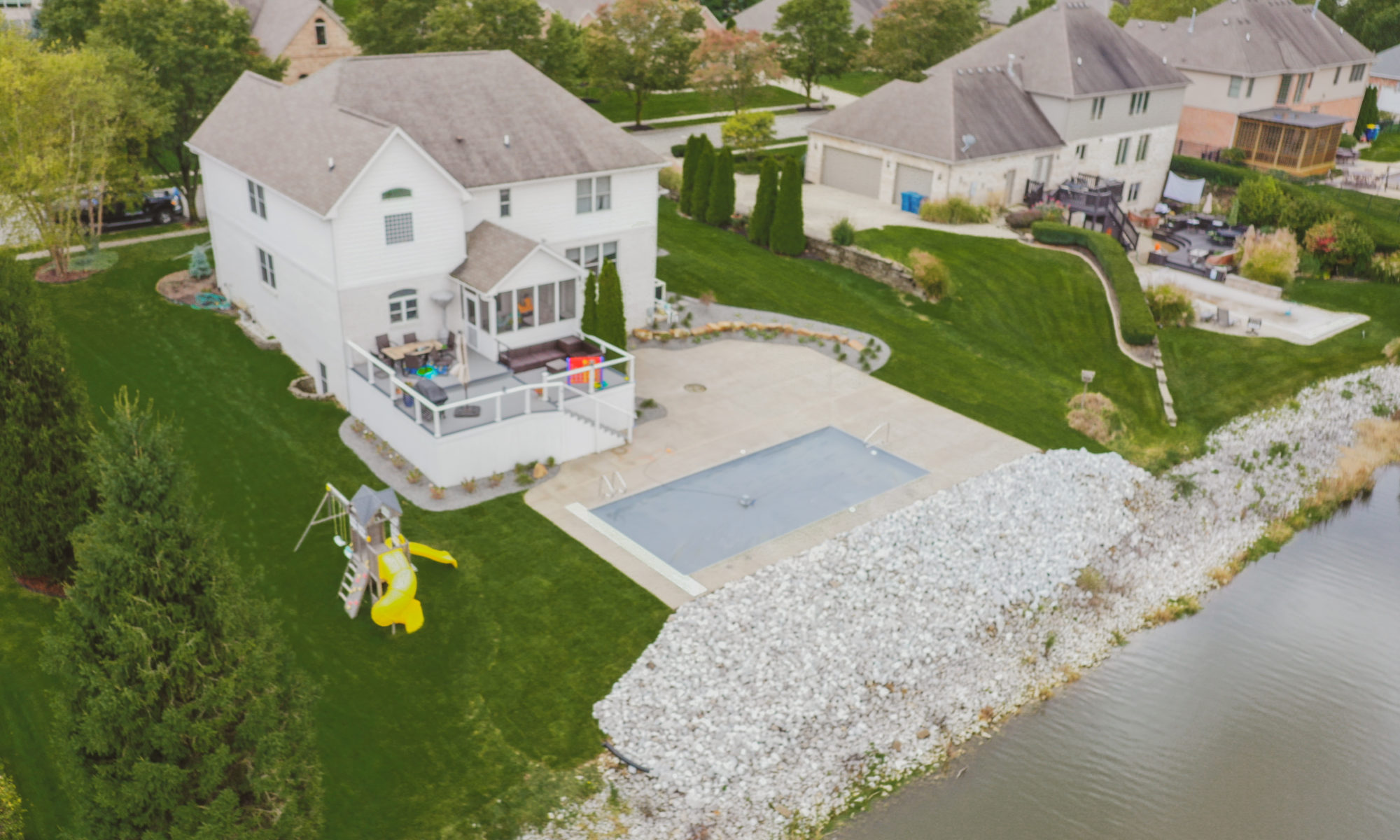 Precision Outdoors Poolside Landscaping Project Custom landscaping plants shrubs small boulders indianapolis Indiana dream backyard