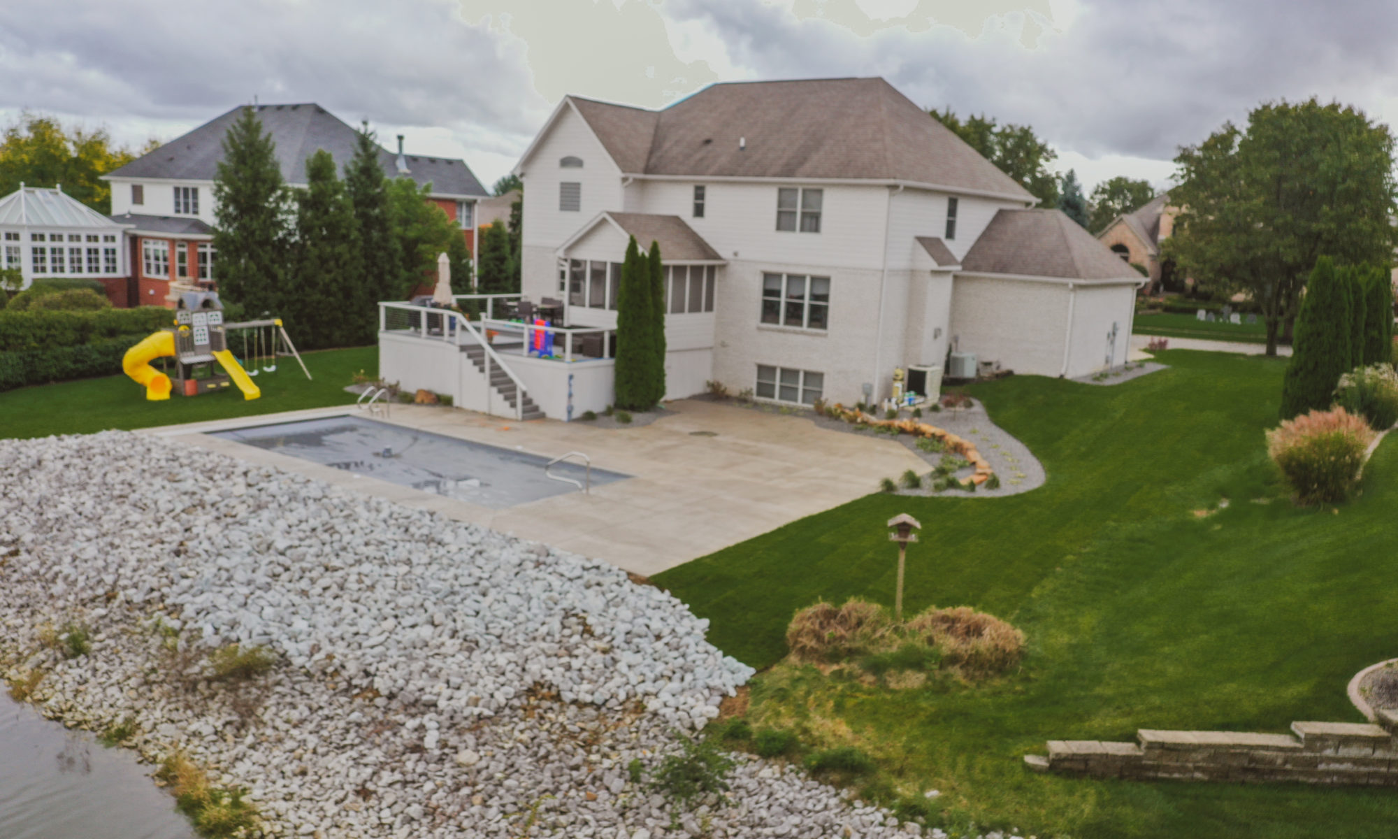 Precision Outdoors Poolside Landscaping Project Custom landscaping plants shrubs small boulders indianapolis Indiana dream backyard