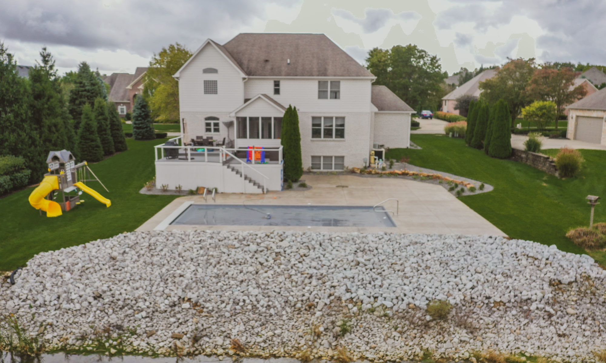 Precision Outdoors Poolside Landscaping Project Custom landscaping plants shrubs small boulders indianapolis Indiana dream backyard