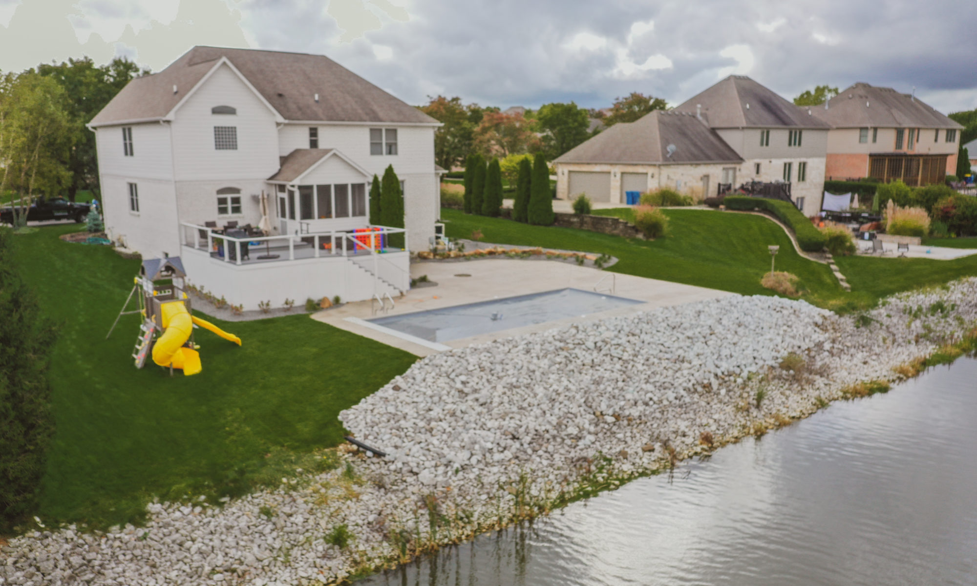 Precision Outdoors Poolside Landscaping Project Custom landscaping plants shrubs small boulders indianapolis Indiana dream backyard