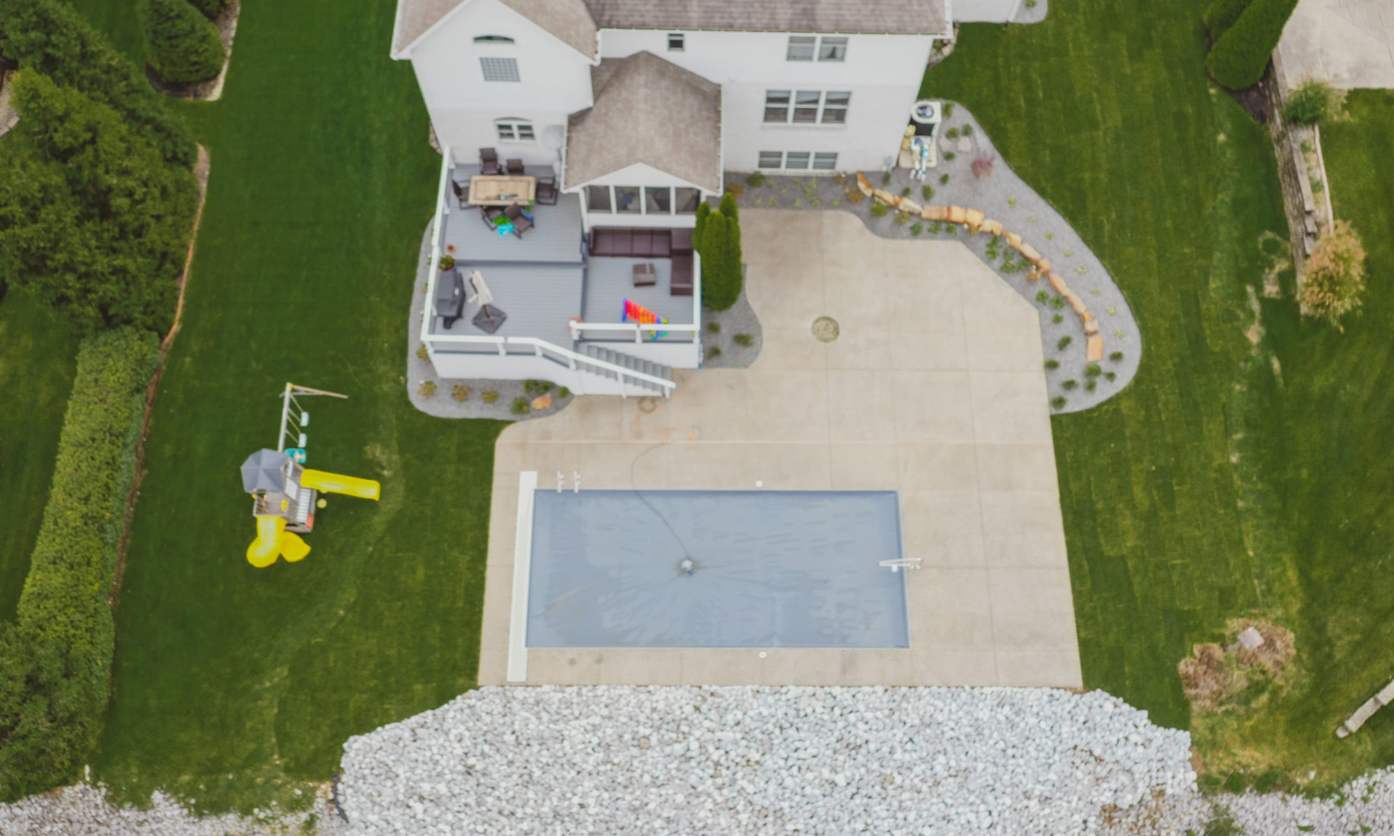 Precision Outdoors Poolside Landscaping Project Custom landscaping plants shrubs small boulders indianapolis Indiana dream backyard
